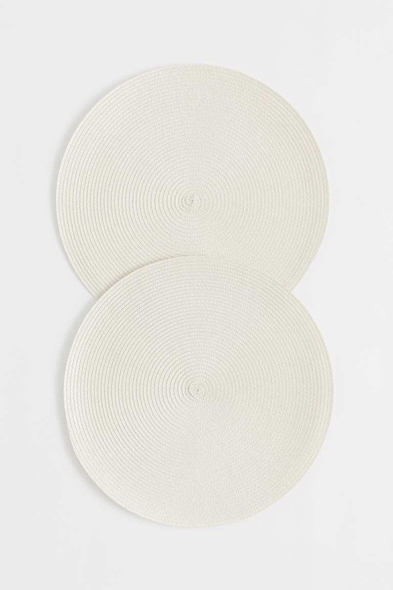 A pair of round table mats in braided imitation straw to protect your table from spills and marks... | H&M (UK, MY, IN, SG, PH, TW, HK)