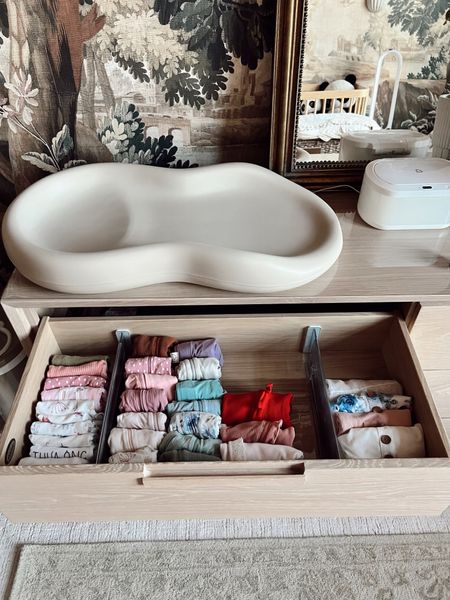 Baby girl nursery with the best changing pad that makes cleaning up so easy, her acrylic dividers for organizing baby clothes, my favorite mural wallpaper, warmer wipes, dresser, mirror and more! Love having everything organized and accessible during her newborn phase  

#LTKbaby #LTKhome #LTKstyletip