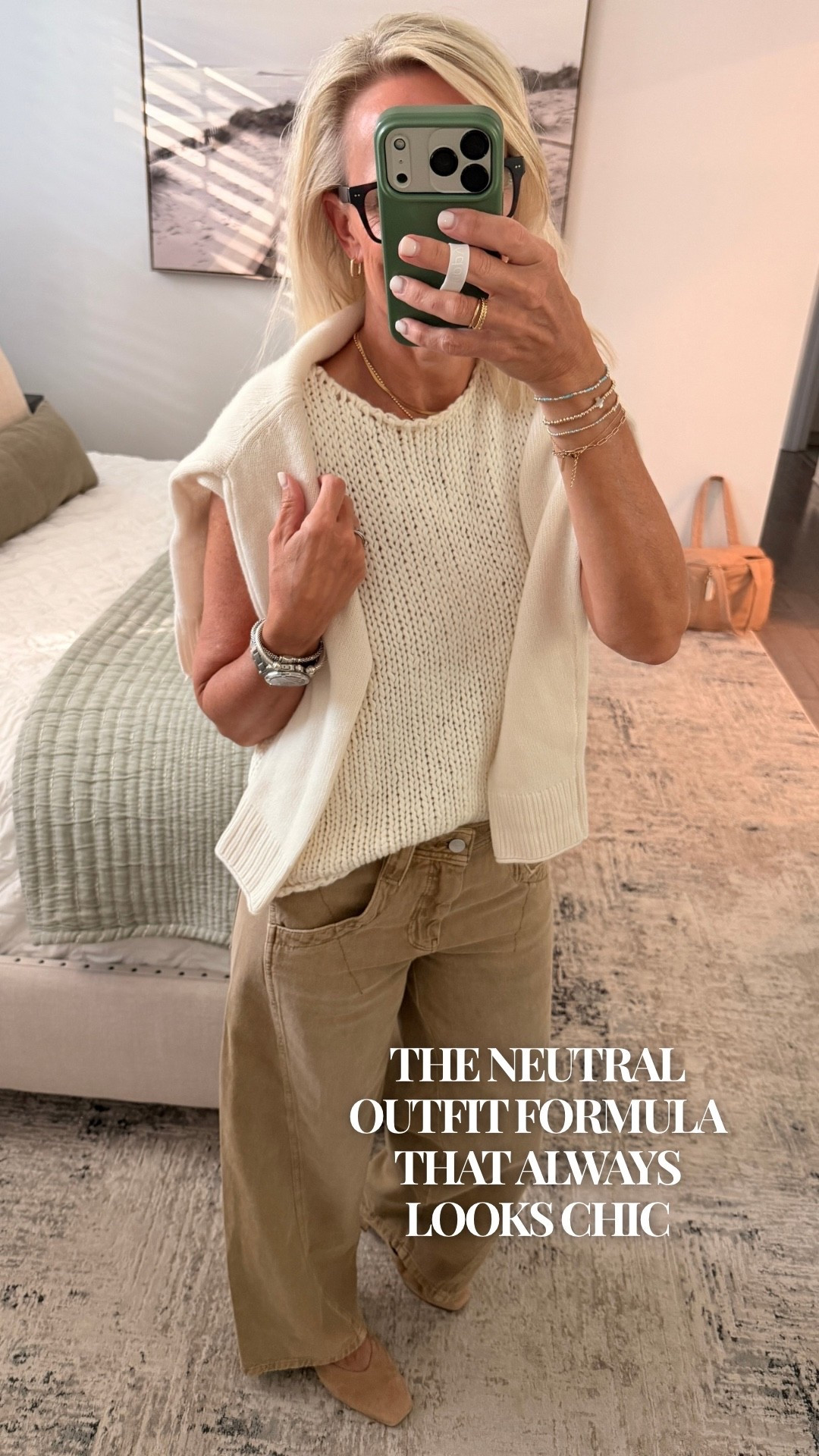 A neutral outfit that feels cozy, polished, and so easy to recreate. I love pairing a cream knit sweater with camel wide-leg pants for an effortlessly chic look. Draping another sweater over the shoulders adds a little extra texture without making the outfit feel bulky. Finish with neutral shoes and gold jewelry, and you’re ready for lunch, a coffee date, or a casual day out.
Save this neutral outfit idea for your next styling day!