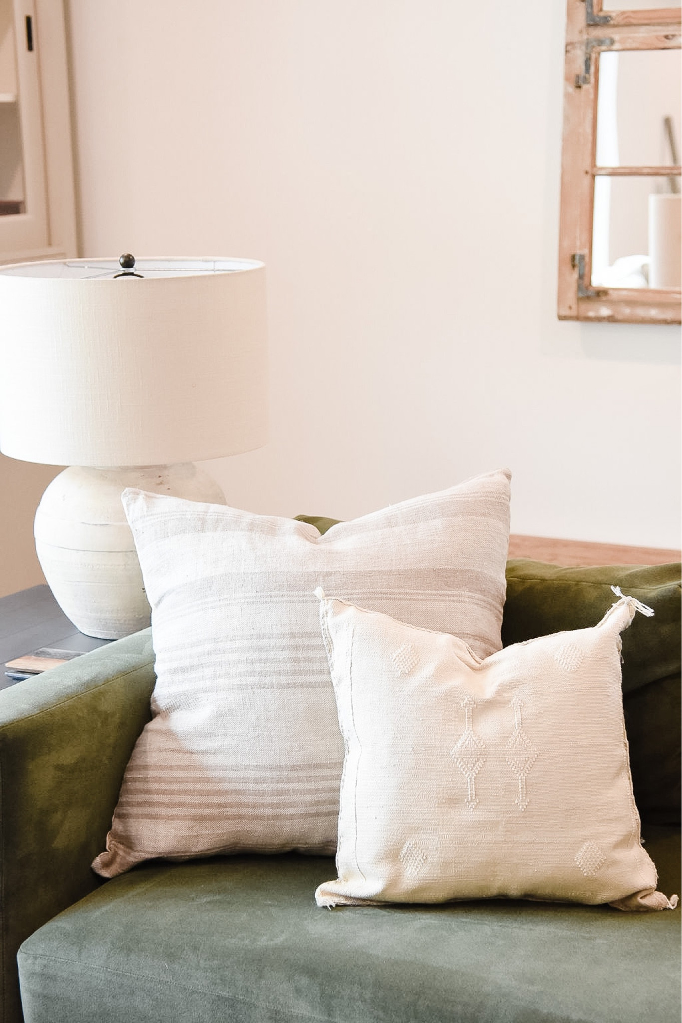 Neutral striped pillows and a velvet green sofa paired with our favorite pottery barn lamp✨



#LTKhome