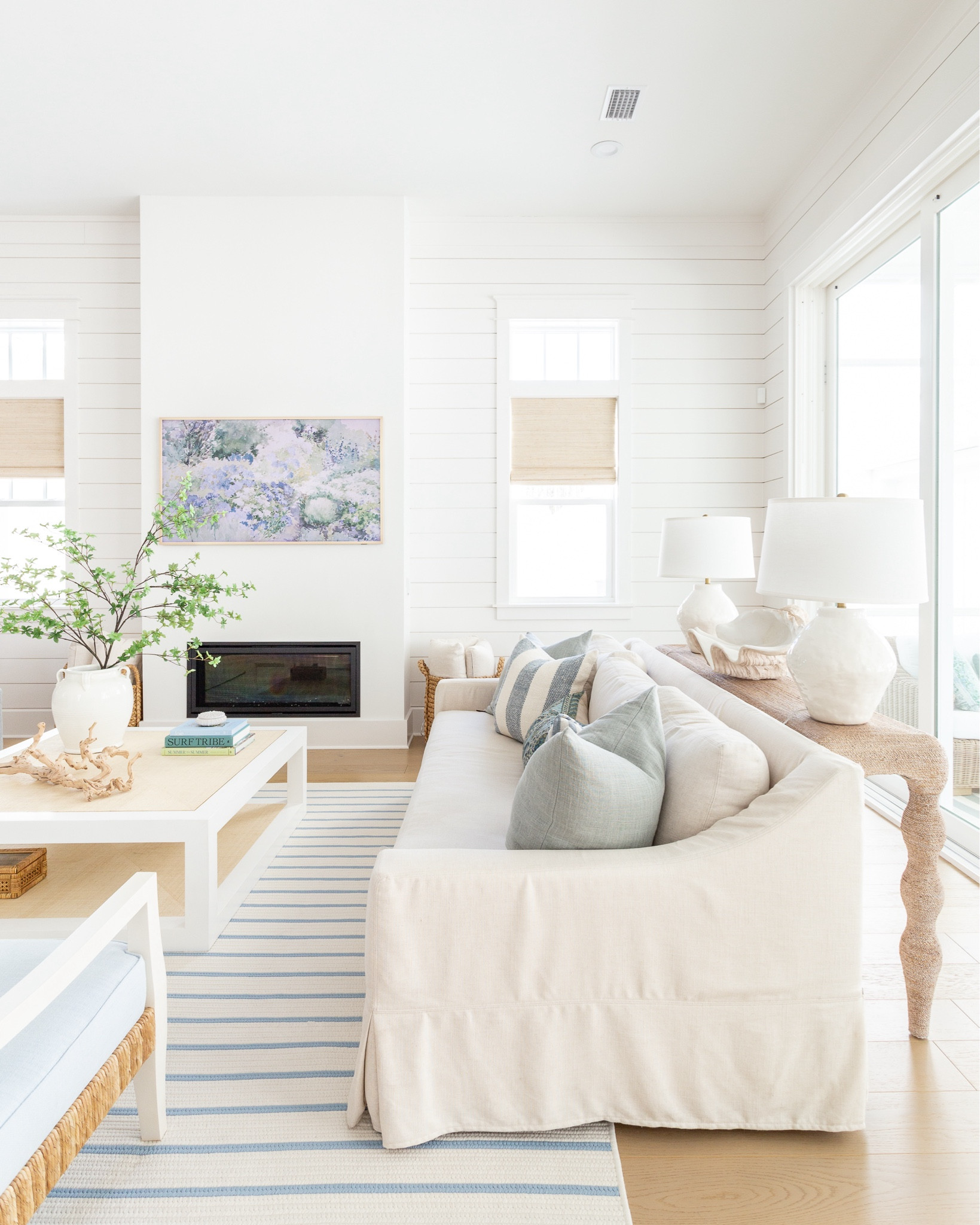 Our living room decorated for spring! Includes our favorite linen sofas, light blue linen armchairs, a blue and white striped rug, raffia coffee table, rope console table, white ceramic lamps, frame tv art for spring, a large greenery branch, blue linen pillows, paisley lumbar pillow, striped pillows, woven Roman shades, and more! See the full spring tour here: https://lifeonvirginiastreet.com/2024-spring-home-tour/.
.
#ltkhome #ltksalealert #ltkseasonal #ltkfindsunder50 #ltkfindsunder100 #ltkstyletip spring decor, spring living room, coastal decor, 

#LTKsalealert #LTKhome #LTKSeasonal