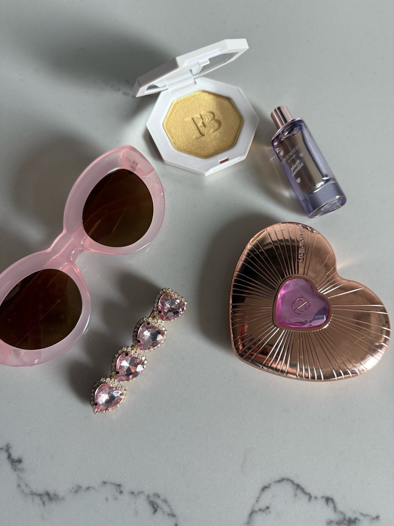 Summer favorites! This charlotte Tilbury heart shaped blush & powder palette has been so fun to carry! I initially bought it for our Disney trip and have loved it since- same story with the Fenty Beauty highlighter- it’s actual pixie dust! The pink sunglasses, baby Ariana Grande Perfume & fun hair accessories are the story of summer. I added my favorite alo pieces too! Happy summer! 



Alo yoga 
Pink shorts 
Pink set 
Pink athleisure 
Pink sunglasses 
Highlighter 
Heart blush 
Summer favorites 
Disney 
SPF

#LTKdayinmylife #LTKgrwm #LTKSeasonal