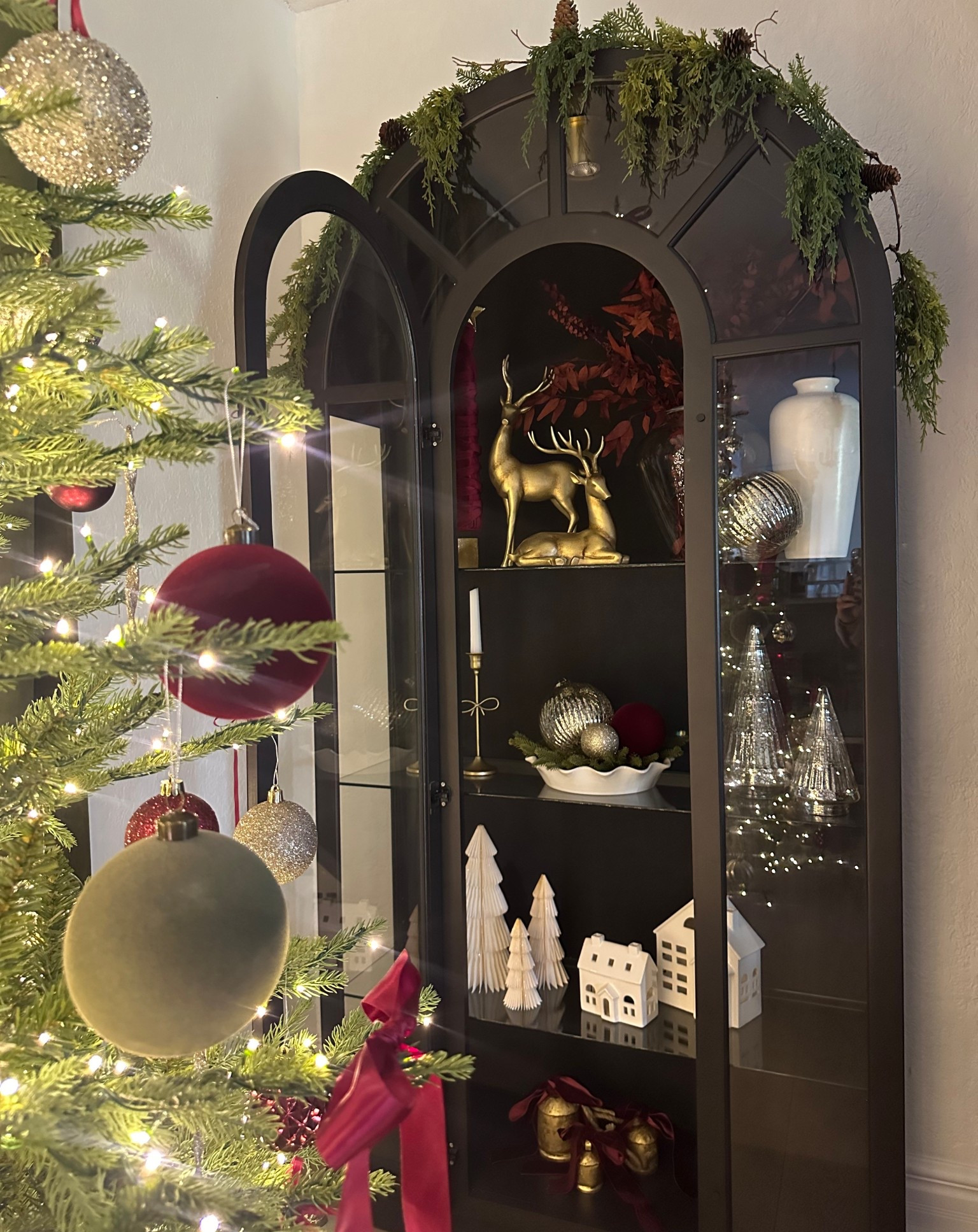 Vintage Arched cabinet styling for Christmas 
Walmart home decor
Pottery barn 
Vintage Christmas 
Ornaments 
Silver and gold 
Reindeer 
Ralph Lauren Christmas 
Pottery barn 
Walmart 
Designer look for less 
Glass cabinet 
Cozy home 
Christmas tree 
Style with me 
Walmart arched cabinet
Vintage decor 
Walmart home 
Vase 
Artwork 
Cabinet 
Dining room 
Credenza 
Moody 
French country #LTKStyleTip

#LTKSaleAlert #LTKHoliday #LTKHome