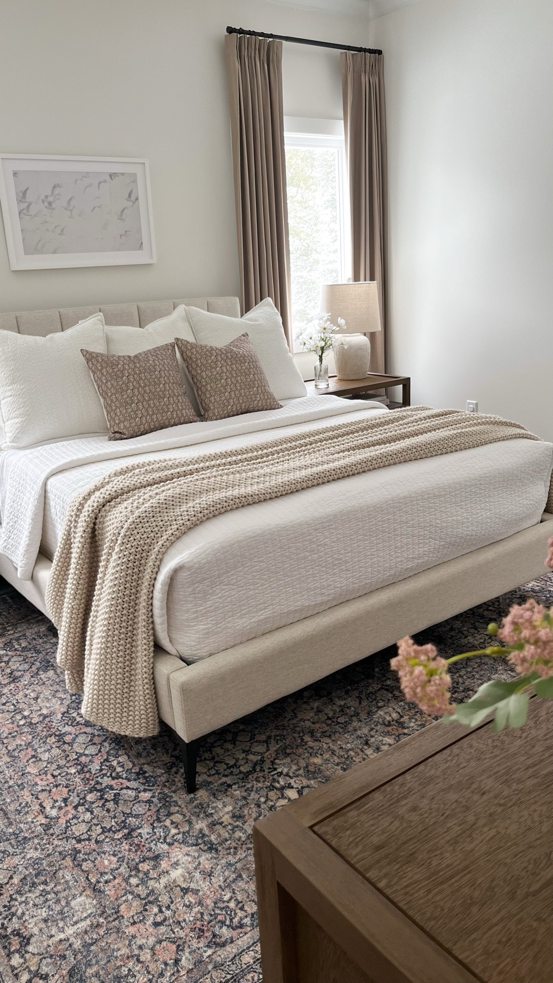 Master bedroom details ✨ 


• Furniture: Crate & Barrel Keane nightstand & dresser in the Driftwood finish 


• Bed: West Elm Emmett channeled headboard and platform bed with metal legs (custom specifics: queen, sand twill fabric & color, vertical tufted headboard style, standard 46” headboard height, dark pewter round leg style & finish)


• Rug: Amber Lewis x Loloi Morgan denim and multi rug 


• Wall art: Cove Prints - “Together” (framed print, 30x20”, white frame finish, with mat)


• Curtains: Amazon black out textured flax linen pinch pleat drapes, in Greybeige, 96” long, hook and black rings included 


• Decor: most home decor is from Target, textured ivory lamps are from Kirklands, faux lilac floral stems are from Pottery Barn


Bedding: 
• Sheets: Cariloha Classic Bamboo Bed Sheet Queen Set in White 
• Waffle knit bed blanket is old from Home Goods, linking similar styles!
• Quilt: white quilt is from Target
• Casaluna chunky knit bed blanket in Natural


Throw pillows: 
• 22” cream chenille boucle pillows are the brand From The Studio Home Textiles, & I found them at Home Goods! Can’t link these exact pillows but I’ll link other similar boucle pillows!
• 18” Foindtower neutral floral print throw pillows in the iced coffee color

#LTKdayinmylife #LTKselfcare #LTKHome