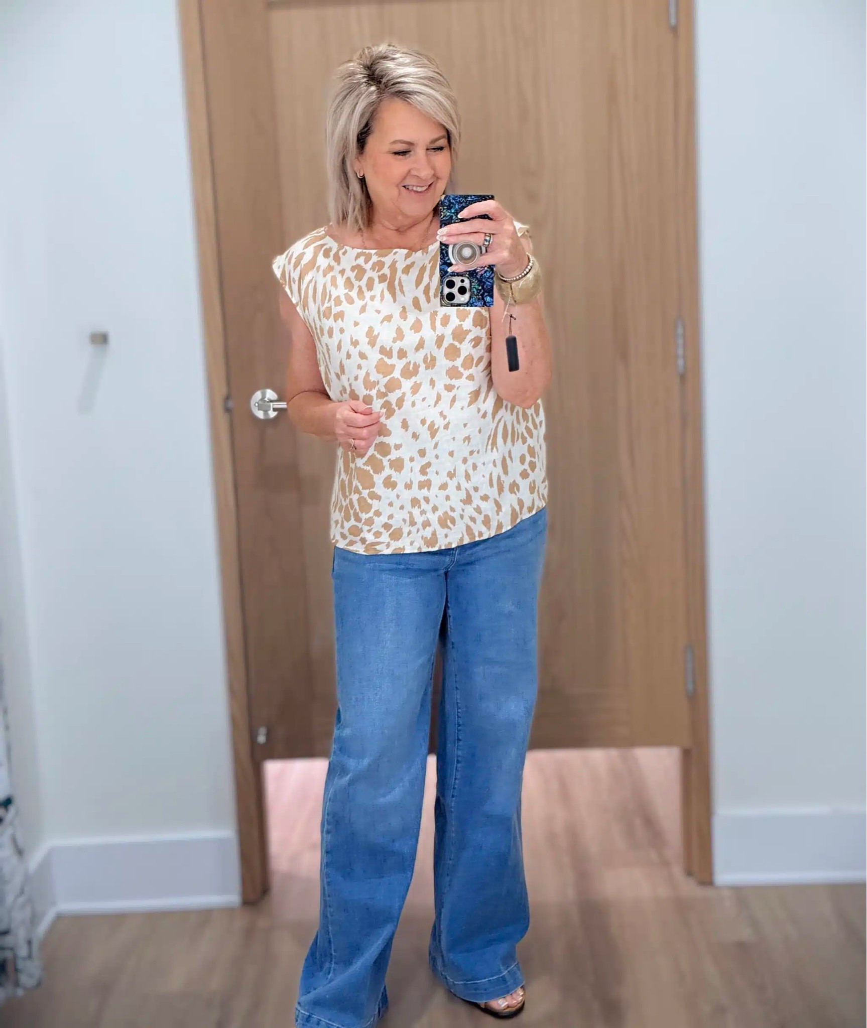 Here is the same printed top, but I’ve styled it with trouser jeans over the wide leg. My top is a size medium and jeans are a size 8.

#LTKootd #LTKOver40 #LTKWorkwear