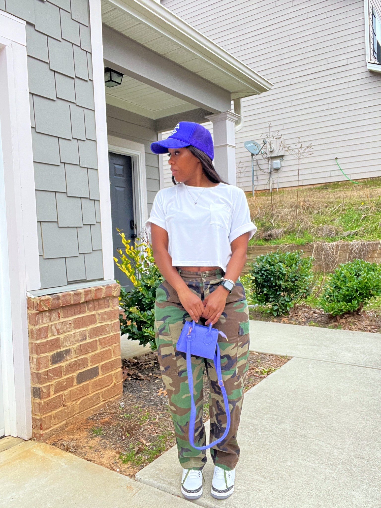 Casual camo pants with basic white t-shirt. I styled these camo pants with a cropped front pocket white tee, purple trucker hat, purple mini crossbody bag, and Jordan 3 dark iris sneakers

#LTKStyleTip #LTKPetite #LTKShoeCrush