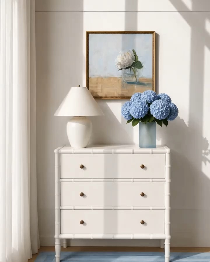 Monday morning, starting fresh with soft morning sunshine shining through an elegant white sheer drape. ✨

This Serena & Lily three-drawer chest is such a beautiful piece for creating a polished vignette on a stair landing like this. Its compact, versatile size allows it to work beautifully in so many places—an entryway, hallway, bedroom, or any quiet corner where you want to stop and enjoy a thoughtfully styled moment.

I love how the clean white silhouette and brass pulls feel fresh and modern, while the bamboo-inspired edges, subtly shaped legs, and classic detailing give it timeless character. The three spacious drawers also make it a wonderful storage solution, keeping everyday essentials tucked away while maintaining a calm, uncluttered look.

Paired with soft blue hydrangeas and a cozy blue rug, the entire vignette feels layered, inviting, and effortlessly coastal chic.

#MondayMorning #SerenaAndLily #ThreeDrawerChest #StorageChest #StairLanding #LandingDecor #InteriorVignette #BlueShagRug #BlueHydrangeas #CoastalChic #ModernClassic #EntrywayDecor #HallwayDecor #LTKHome

#LTKdayinmylife #LTKHome #LTKSaleAlert