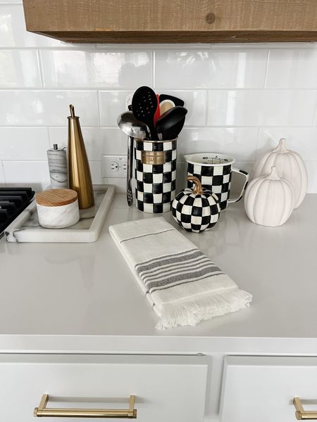 Fall kitchen decor with white ceramic pumpkins, black and white hand towels, Mackenzie-Child measuring cups and pumpkin! Simple but pretty for fall 

#LTKSeasonal #LTKstyletip #LTKhome