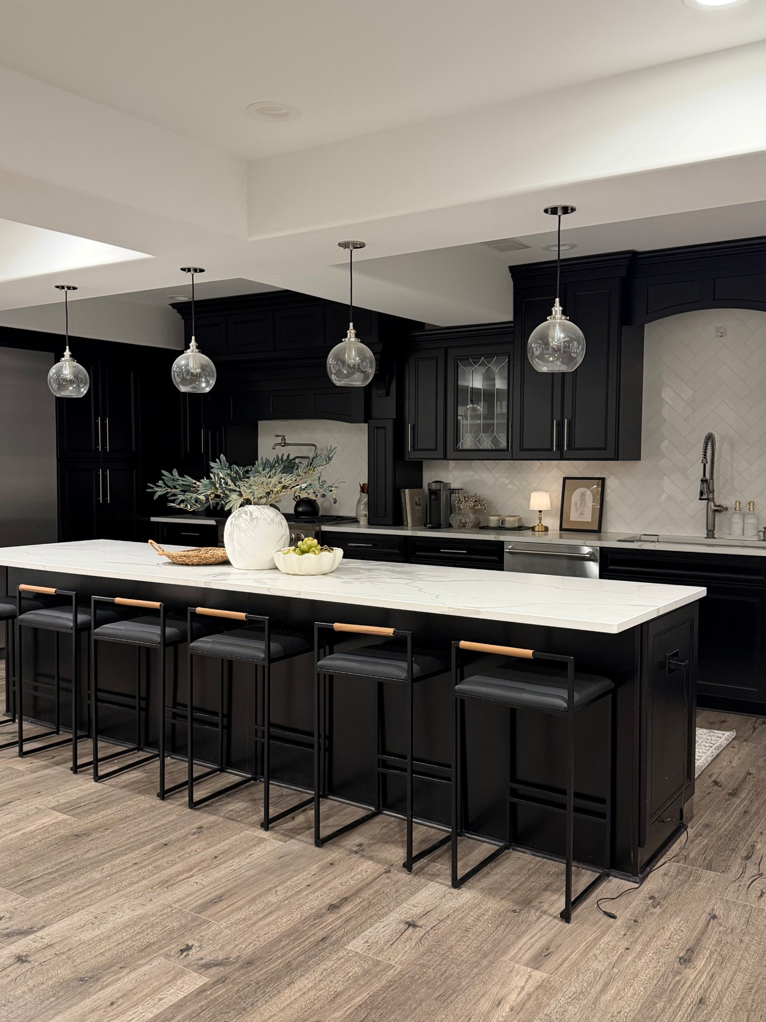 Our kitchen is one of my favorite spaces in our home 🤍

The black cabinetry, warm wood floors, and simple glass pendants keep it classic while the oversized island makes it perfect for everyday life and entertaining. Linking some of the pieces and similar items here.


#LTKHome #LTKSaleAlert