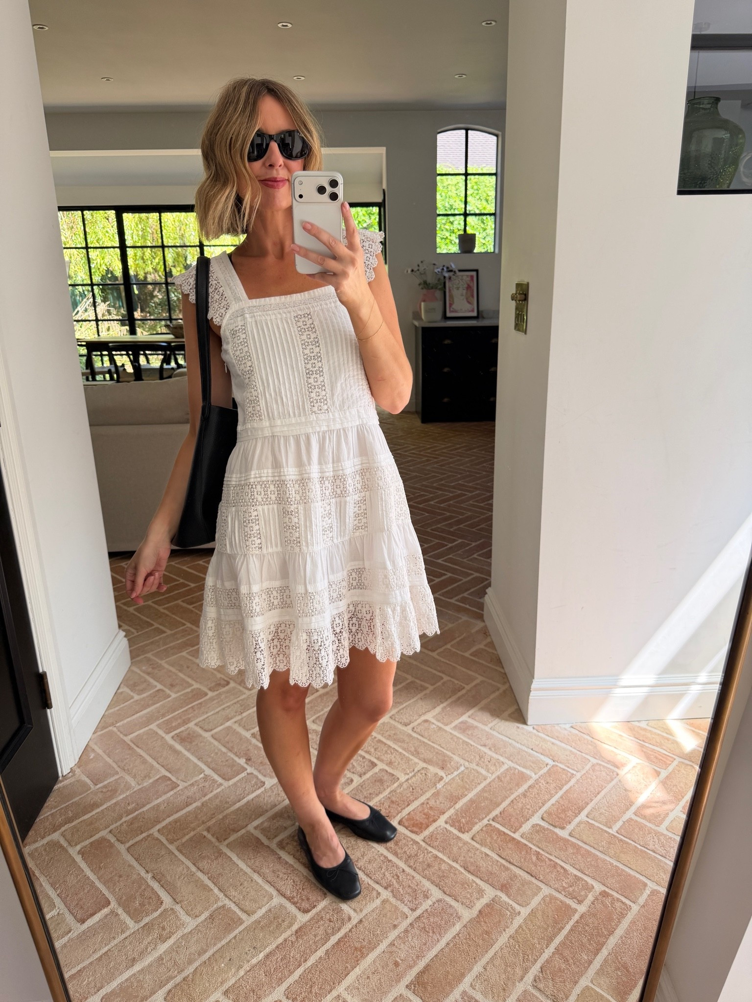 white lace mini dress, broderie anglaise dress, white broderie dress, lace tiered dress, scallop hem dress, square neck mini dress, flutter sleeve dress, white cotton dress, white summer dress, white going out dress, black leather tote, oversized black tote, black shoulder bag, black loafers, square toe loafers, black leather flats, black sunglasses, cat eye sunglasses, gold bracelet, how to style a white dress, white dress black accessories, feminine summer outfit, romantic dress styling, garden party outfit, wedding guest dress, event outfit women, effortless chic, French girl style, mirror selfie style, white dress outfit ideas

#LTKdatenight #LTKpartywear #LTKeurope