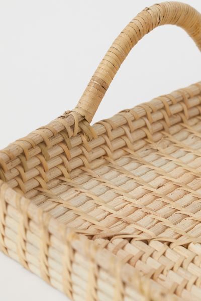 Rectangular tray in rattan with a handle on each short side. Low rim. Width 11 in. Length 17 in.W... | H&M (US)