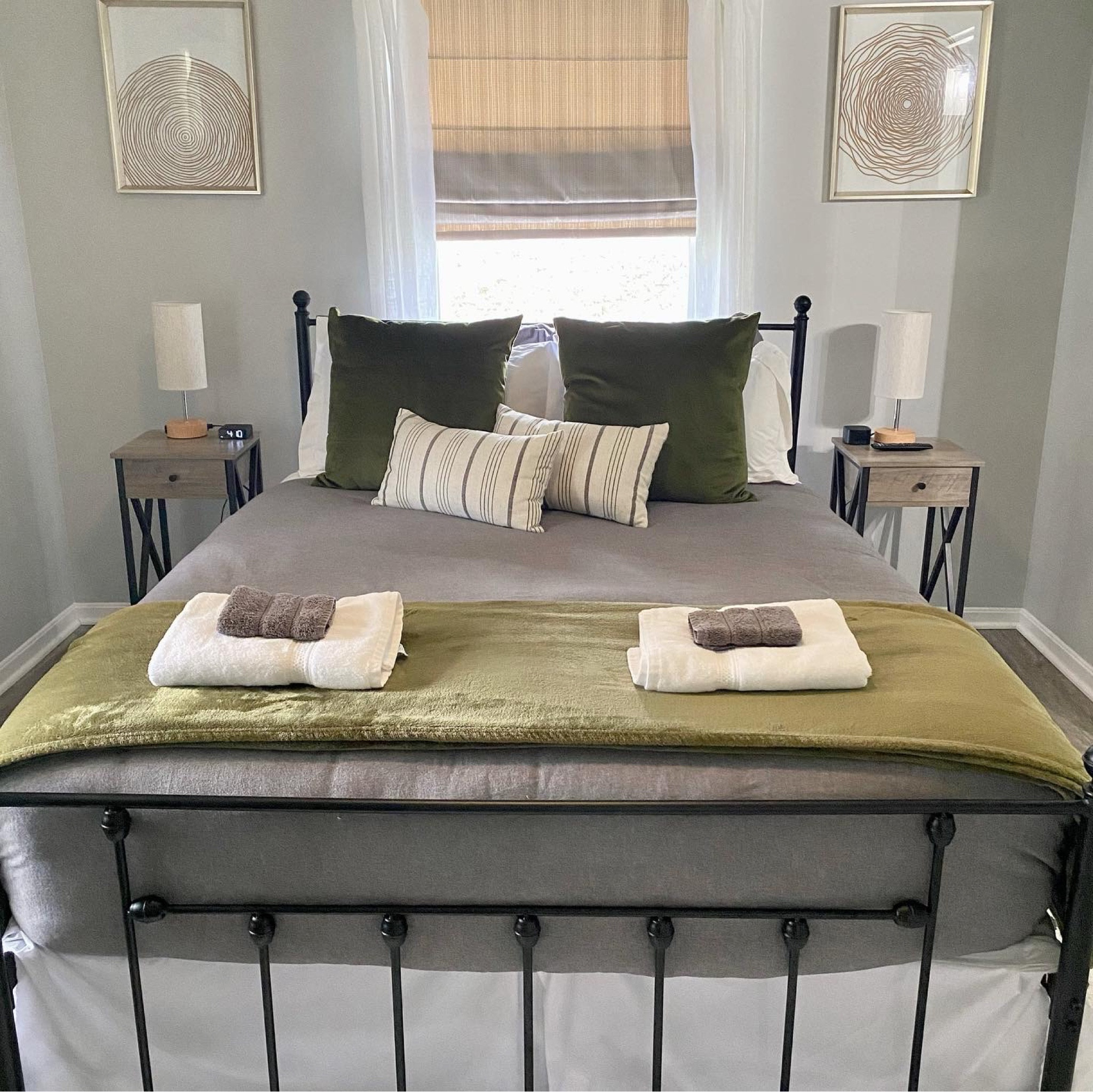 Vacation rental home master bedroom decor. Modern farmhouse design with iron bed, blackout shades, and matching nightstands. 

#LTKstyletip #LTKhome #LTKtravel