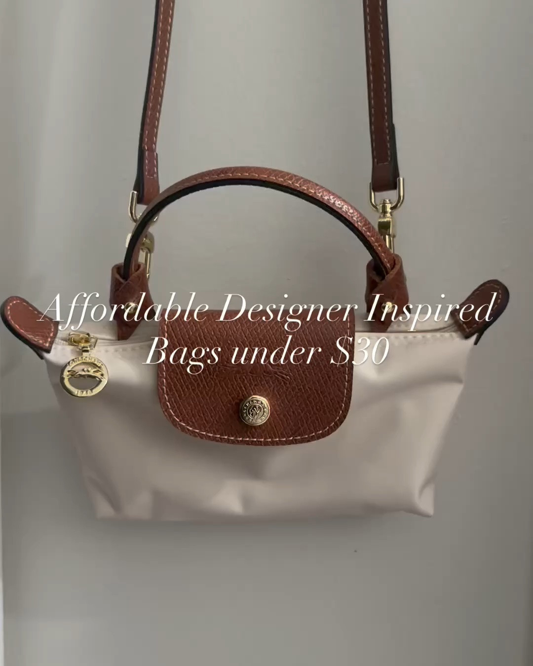 Designer inspired mini canvas bag with a crossbody strap under $20. It’s back in stock. The color I have is Paper White.