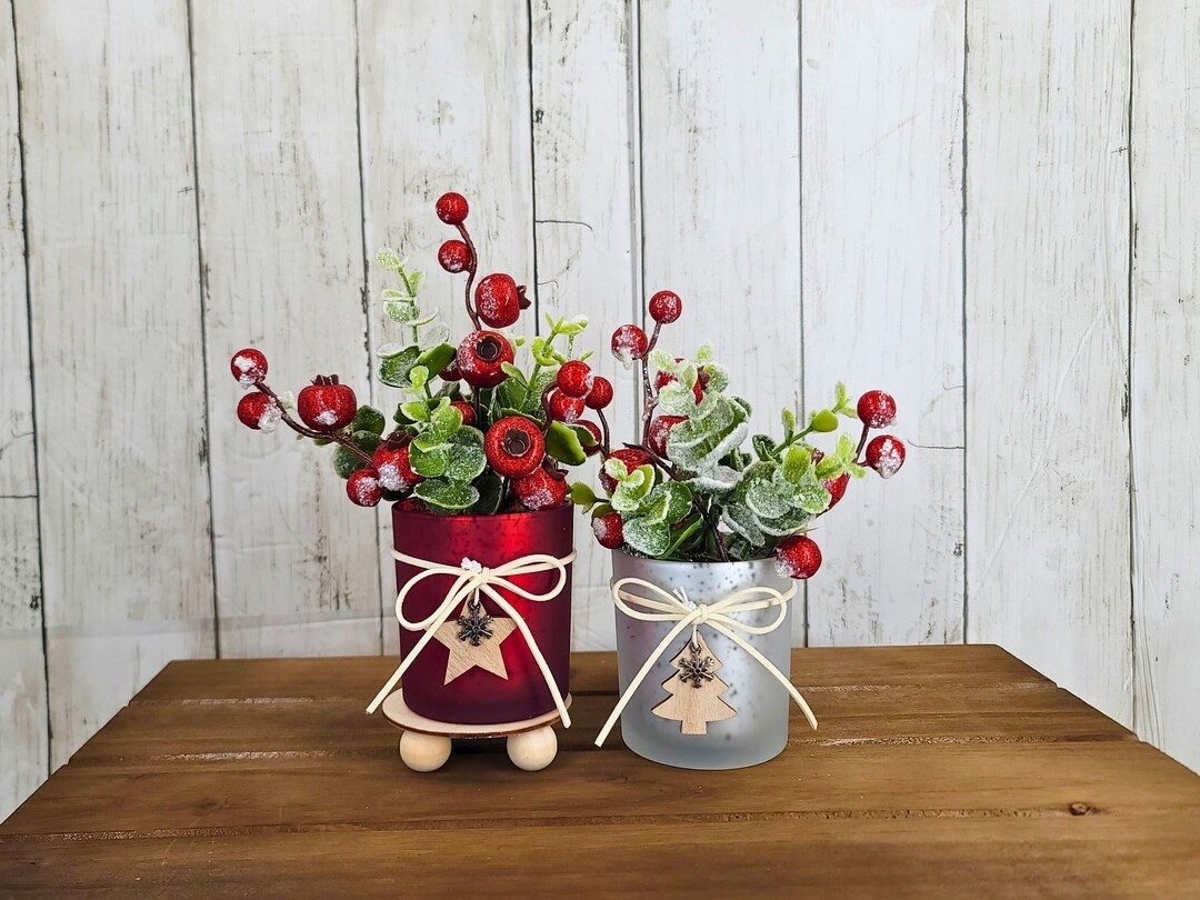 Add a festive touch of elegance to your home with these handcrafted Christmas floral arrangements by TobiasAndMiller. Each design features frosted eucalyptus and red winter berries arranged in your choice of a red or white vase, finished with a charming wood cutout accent. Perfect for shelves, mantels, or tiered trays, these pieces bring cozy holiday warmth to any space—beautiful, sustainable, and made with care in Pennsylvania. 🎄❤️✨

#ChristmasDecor #HolidayCenterpiece #EtsyFinds #WinterStyle #FestiveHome #ChristmasVibes #HandmadeHoliday #TieredTrayDecor #RusticChristmas #TobiasAndMiller

#LTKSeasonal #LTKHome #LTKFindsUnder50