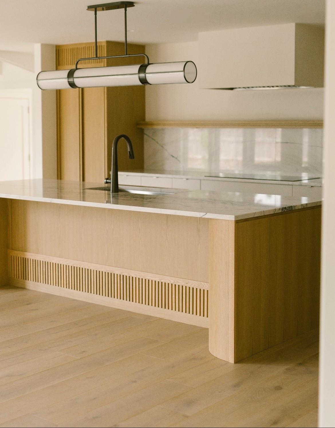 Clean lines + warm wood + sculptural lighting. 
✨We used the 52" version of this fixture to anchor the island and add contrast to this soft, neutral kitchen. It's one of my favorite picks for modern organic spaces. Tap to shop the exact light.  ✨

#KitchenDesign #LTKhome #LightingGoals #ModernOrganic #DesignerDetails #NeutralKitchen

#LTKHome