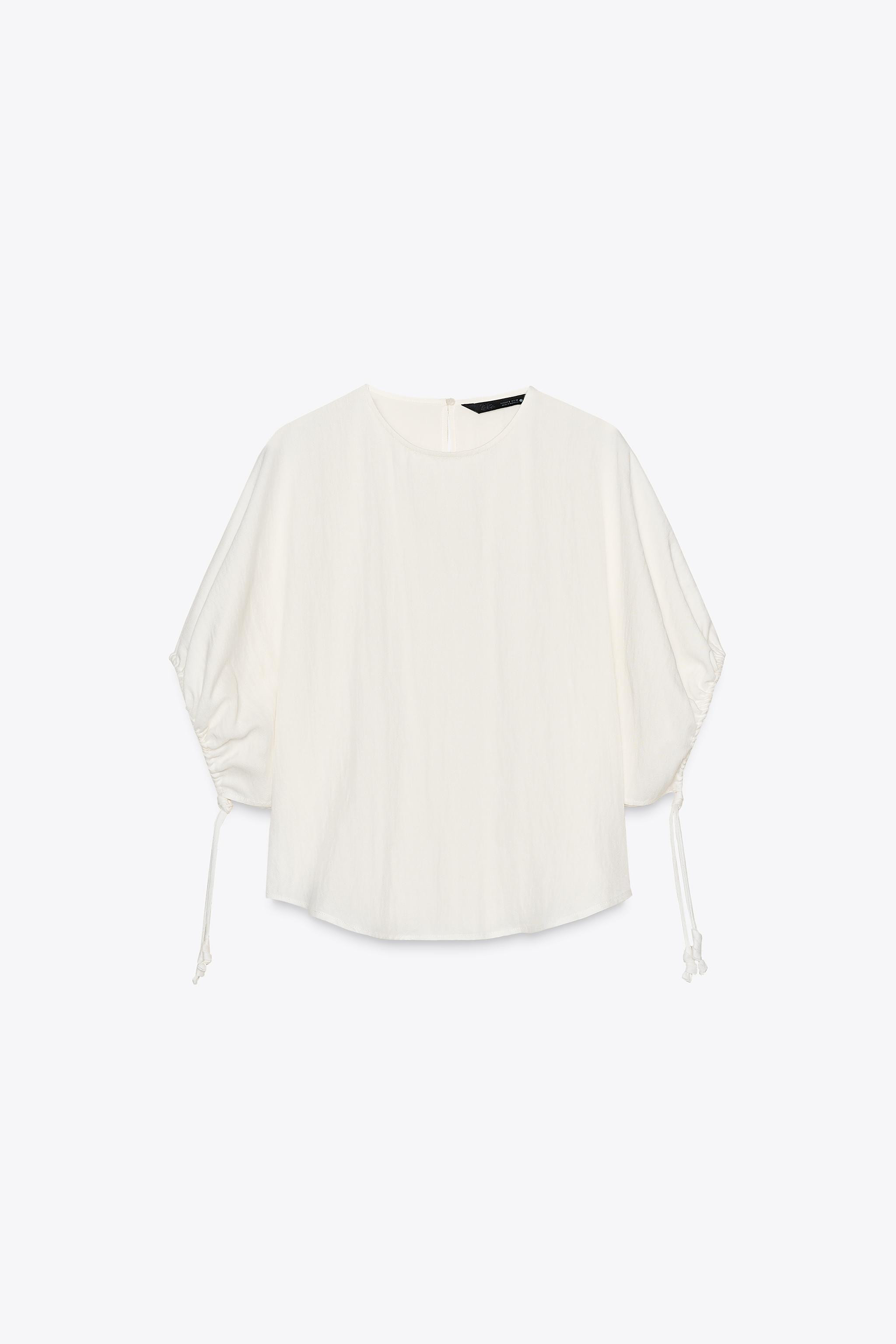 ZARA WOMAN COLLECTIONBlouse made from a lyocell blend yarn. Round neck and short puff sleeves wit... | Zara UK