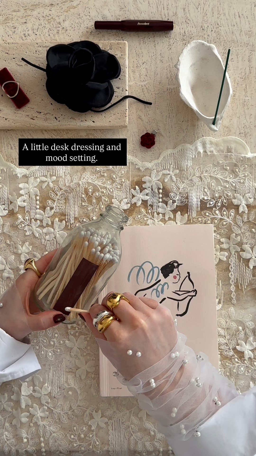 At my desk with ink and incense 🕯️ burgundy pen ready, tulle gloves on, heart ring giving me warmth… writing, dreaming, plotting quietly beneath.
.
writing desk edit | writer aesthetic | fountain pen | incense holder | tulle gloves | heart ring | dome rings | white shirt outfit | romantic aesthetic | slow living | creative desk setup | jewellery edit | everyday jewellery | desk styling | timeless style | gift guide | Black Friday edit | cosy workspace 

#LTKwinter #LTKuk #LTKgiftguide