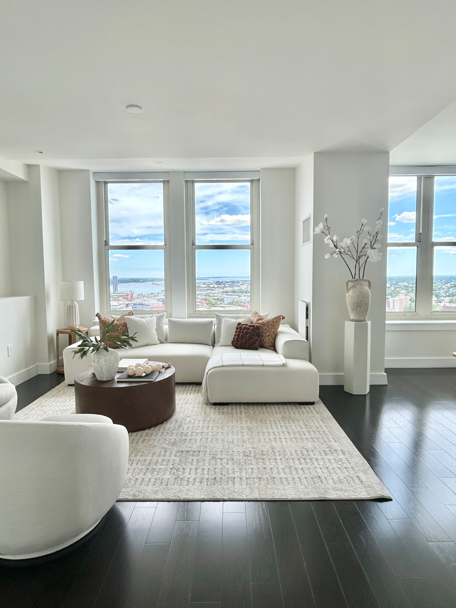 Find quiet luxury in this living room with a white sectional and brown drum coffee table. 

#sectional #livingroom #pedastal #loloirug

#LTKHome
