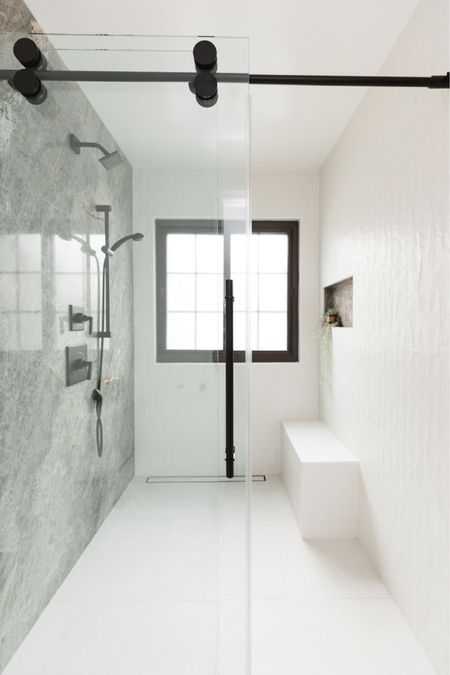 Modern Bathroom 

Sleek tiles, clean lines and streamlined glass doors for a simple, clean design. Walk-in shower, large shower slabs, matte black hardware, primary bathroom. 

#LTKHome