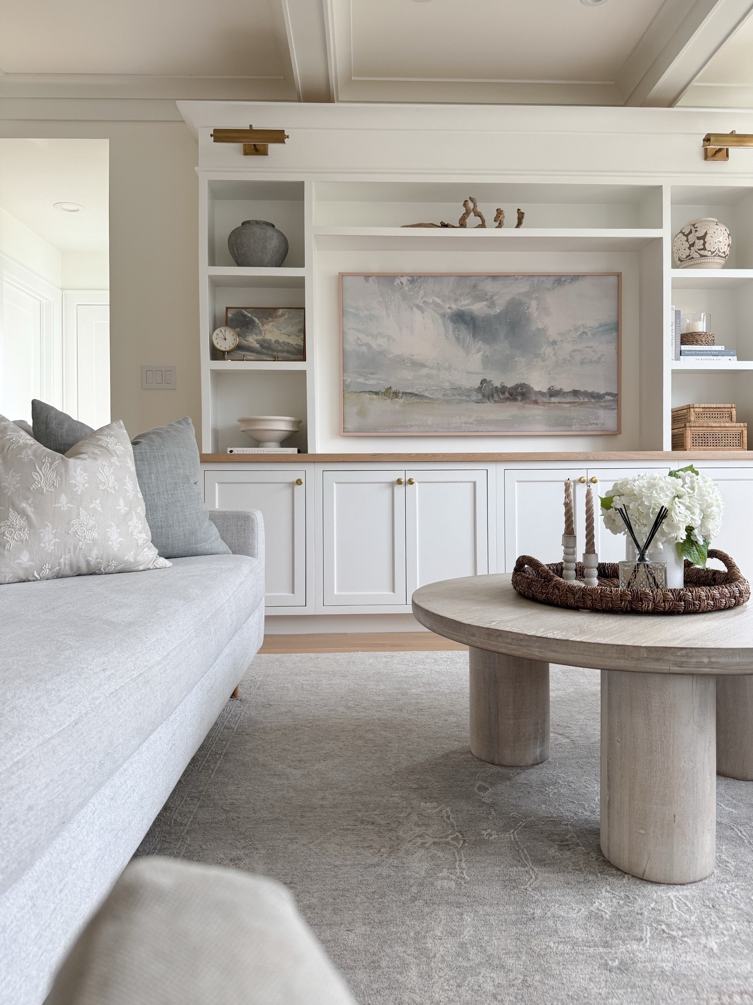 A few favorite details from our great room. Our best-selling light gray rug adds subtle pattern and softness, while the solid wood coffee table brings warmth, durability, and a timeless foundation to the space. I’ve kept the shelf styling simple and collected with natural textures, pottery, books, and a few beautiful storage pieces that hide all the everyday kid clutter. A mix of practical, family-friendly pieces that still feel elevated and cozy. 🤍 Everything linked!

#LTKSaleAlert #LTKdayinmylife #LTKHome
