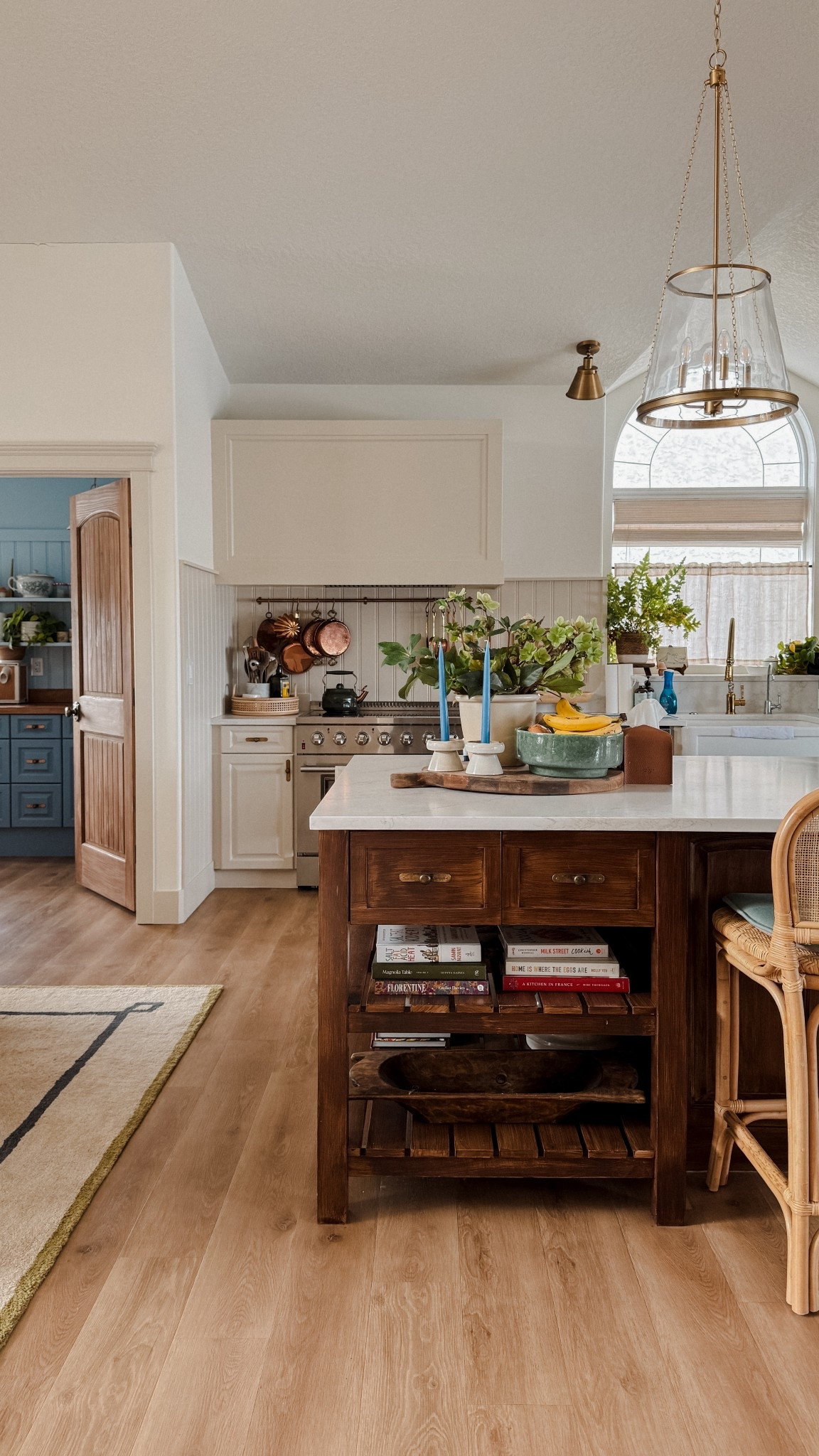 Cozy cottage kitchen lighting, wainscoting, rugs, pine doors, counter stool, farmhouse sink

#LTKHome