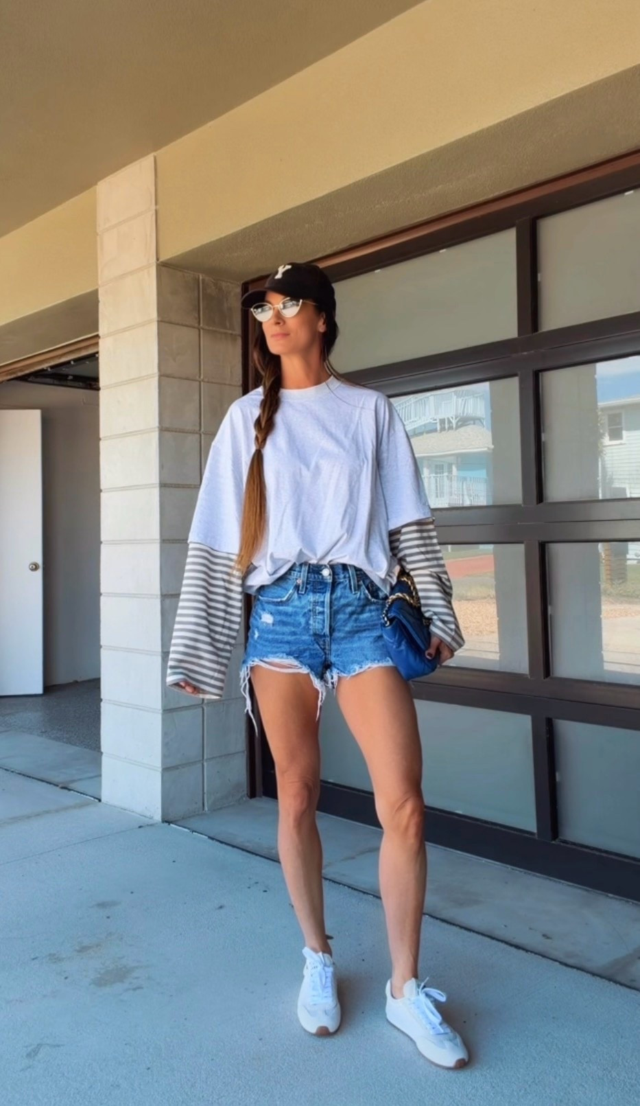 Fall dressing, Florida edition. 💙 Loving the striped sleeve detail on this oversized tee with distressed denim shorts, white sneakers, and a baseball cap. The blue bag adds just enough extra—because apparently even my casual outfits need accessories. 😉 Shop the look here!

#LTKdayinmylife #LTKgrwm #LTKootd
