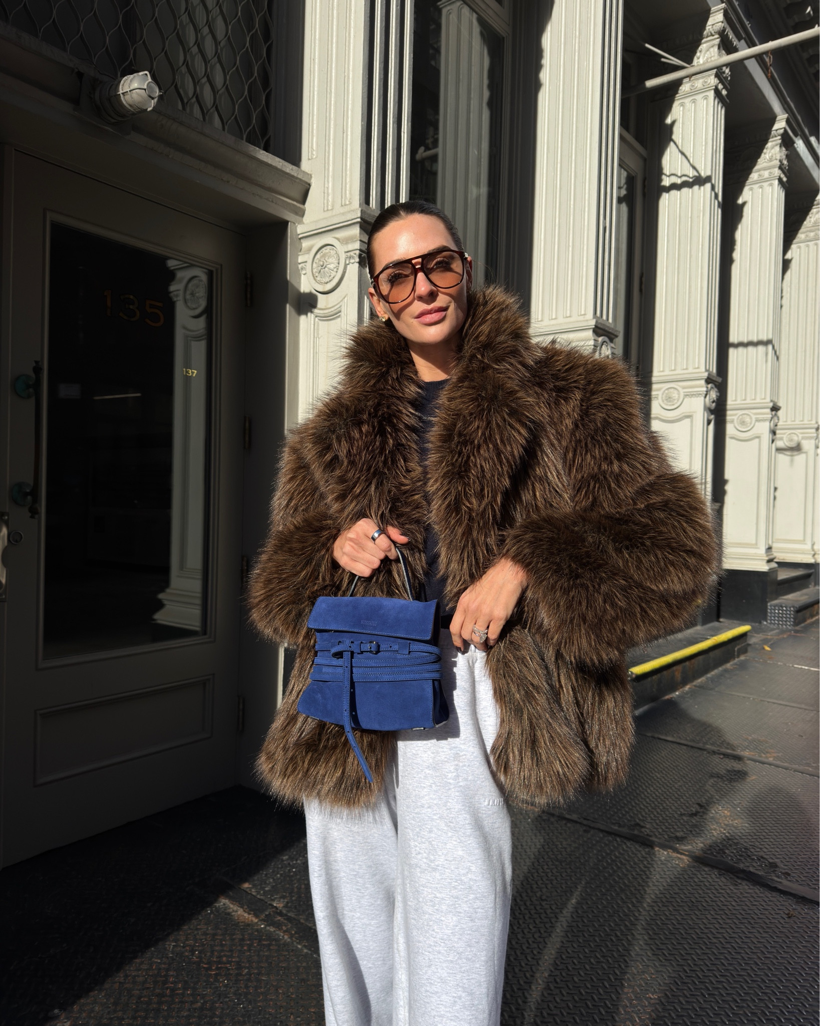 Skims sweatpants, navy cashmere sweater, Magda butrym faux fur coat, moschino tie me bag, YSL sunglasses, new balance 530 sneakers 

#LTKootd