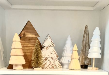 Wood trees vignette. How to style your shelves for the holidays. #christmasdecor #christmastrees #holidayshelfstyling #christmashome #bottlebrushtree #goldtrees 

#LTKhome #LTKSeasonal #LTKHoliday