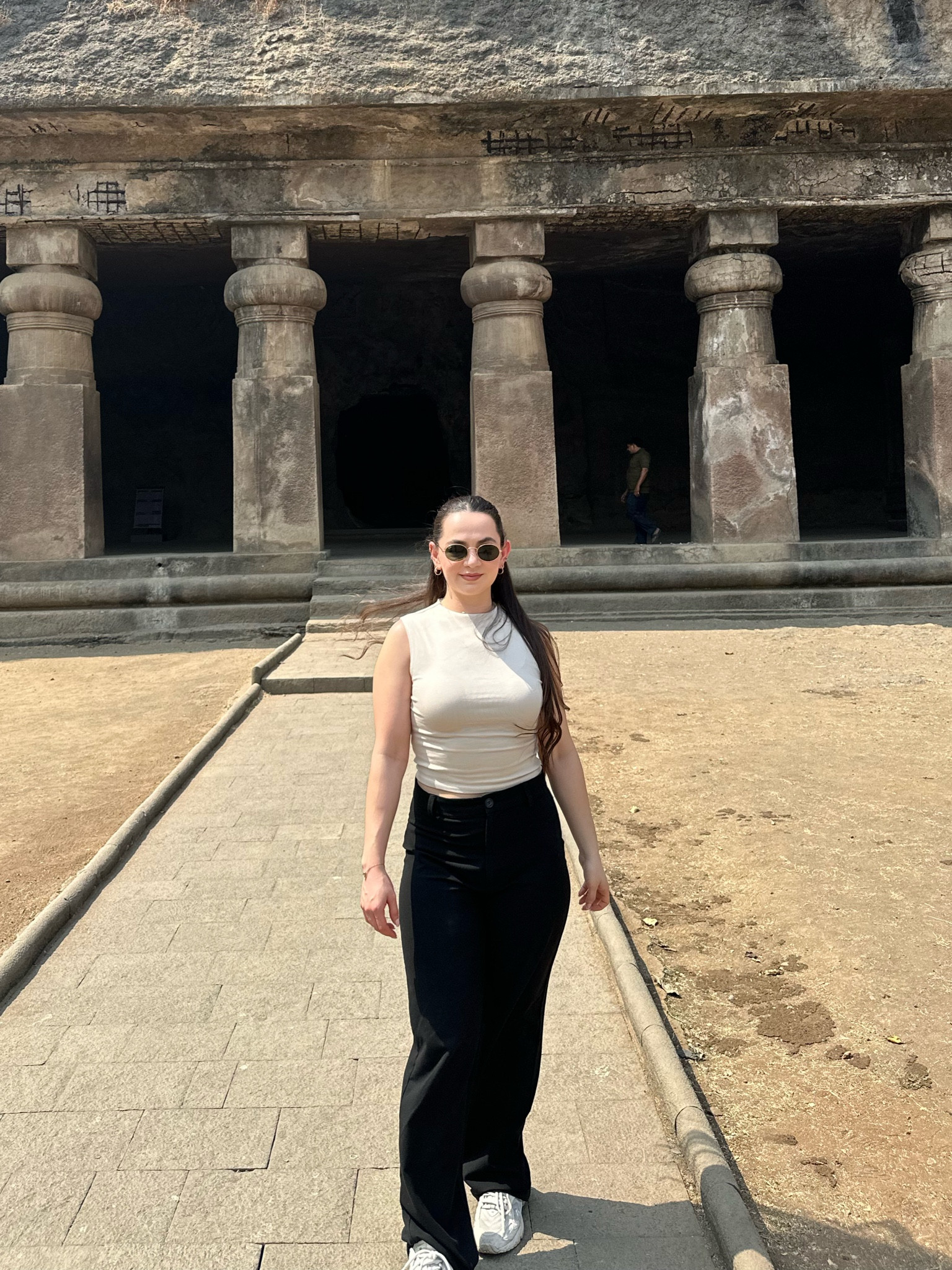Comfortable, cute & simple outfit I wore on my trip to India. I linked a similar top! Mock neck tank top. Black trousers. Travel outfit. Vacation outfit. Nude top. Cream tank top. Sleeveless shirt. Comfortable casual wear. Business casual wear. Walkable sneakers. New balance 725. comfortable shoes. 

#LTKshoecrush #LTKtravel #LTKfindsunder50