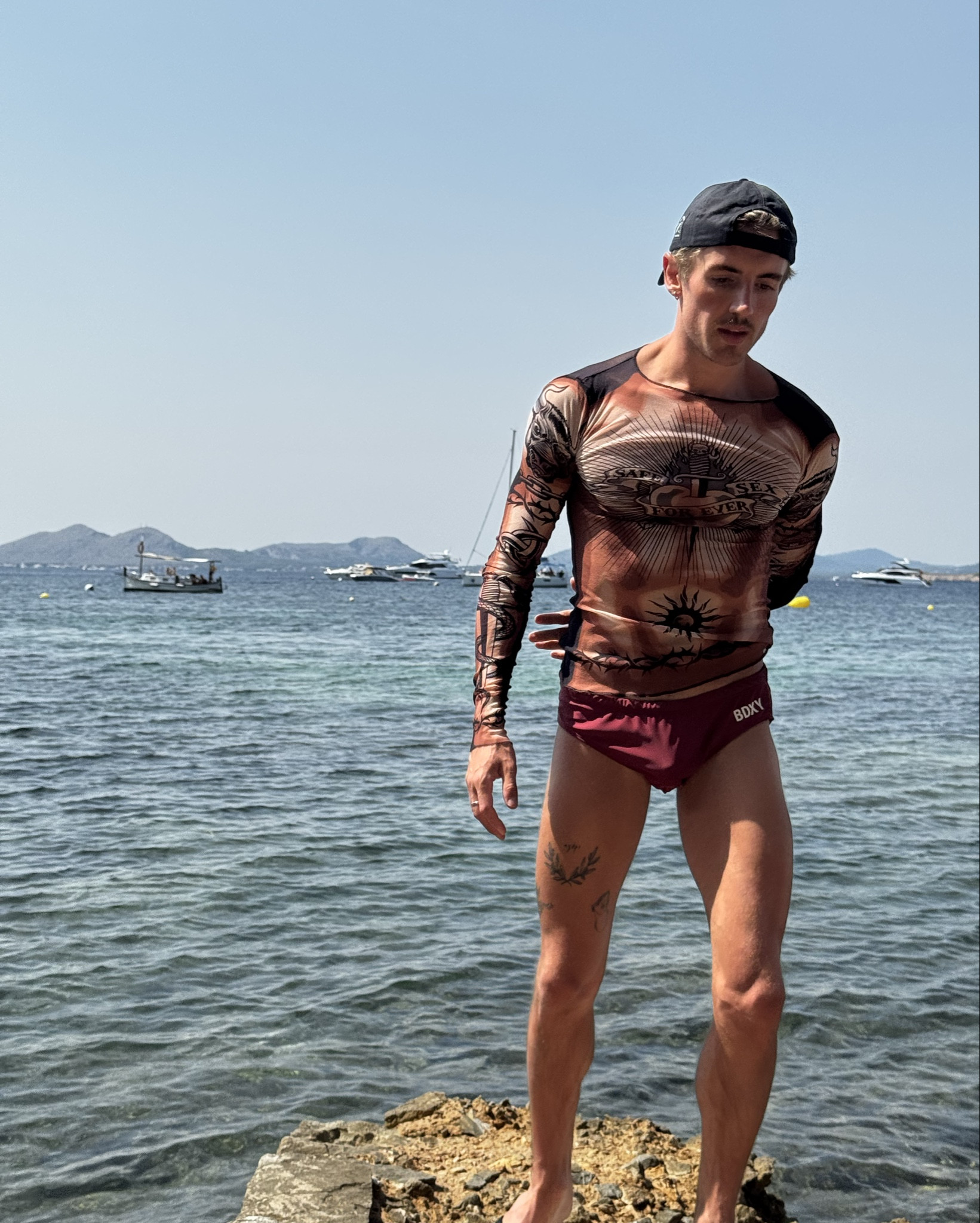 Jean Paul Gaultier mesh summer look with speedos and cap 

#LTKsummer #LTKluxury #LTKmens