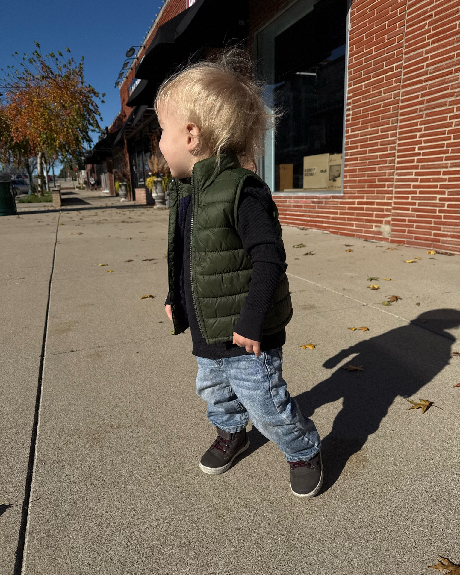 Toddler Boy fashion- black waffle knit long sleeve top with a green puffer vest with jeans 

#LTKKids #LTKFamily #LTKBaby