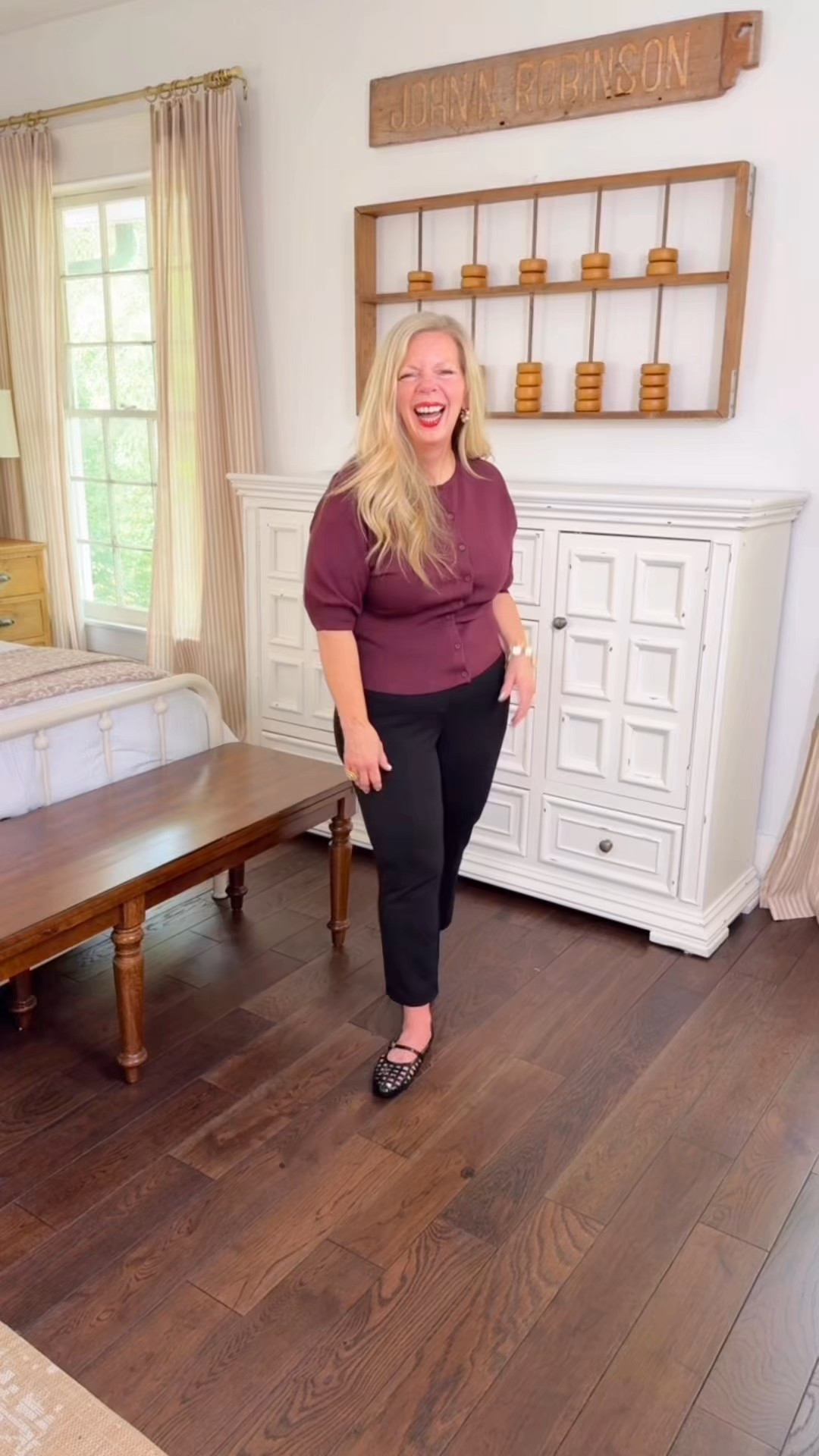 This sweater is so flattering. It has a wide ribbed waistband with buttons up the front and longer sleeves. I love it because it hides my arms. It does run true to size. I’m wearing a medium here. It also comes in several different colors.