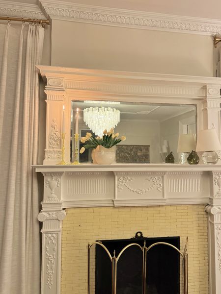 Nighttime living room details- glass candlestick, chandelier, glass lamp, faux tulips, crown molding, ceiling molding 

#LTKstyletip #LTKhome