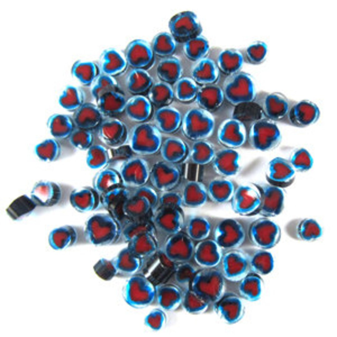 With a bright red opal inside and a transparent blue halo, this glass heart murrine conveys a ple... | Etsy (US)