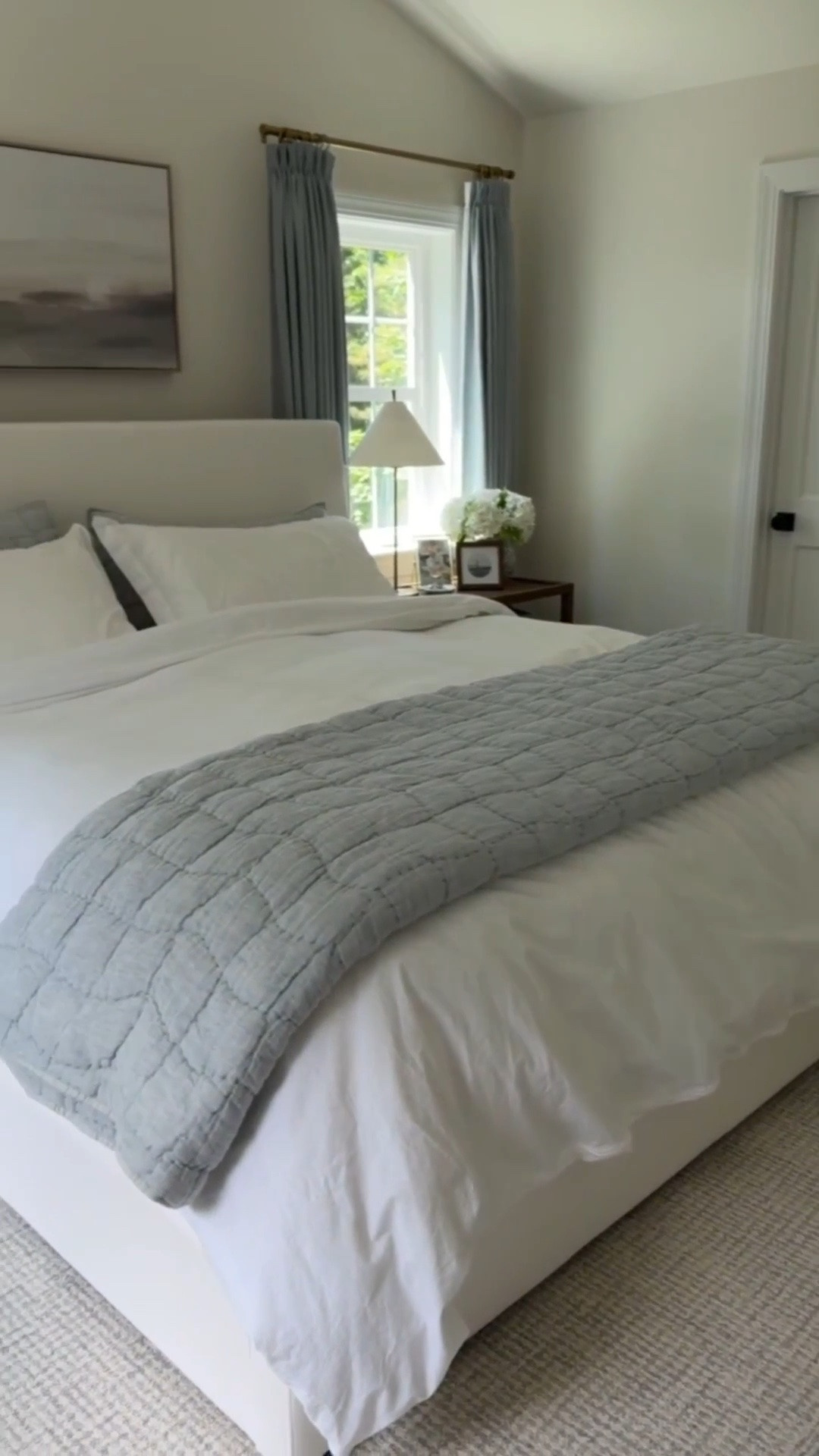 Modern coastal primary bedroom with touches of blue that is functional and beautiful! Shop it here! Pottery Barn quilt on sale!

#LTKHome