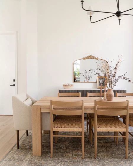 Simple and modern dining room inspo! I really love the natural, organic look with a wooden table and chairs and comfy upholstered dining chairs. I also like the marble top sideboard, vintage-style gold mirror, and black chandelier.
#modernorganic #furniturefinds #interiordesign #winterrefresh

#LTKhome #LTKfamily #LTKstyletip