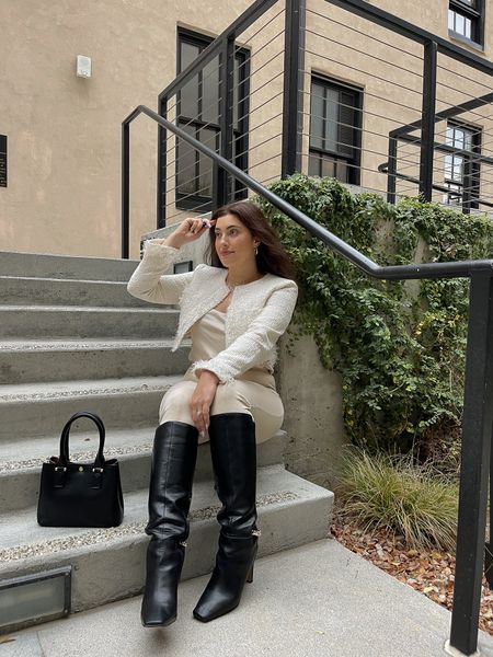 Cream tweed cropped jacket with feathers, cream satin camisole, heeled tall chain boots in black, black vegan leather boxy handbag, gold hoop earrings all from Express 

#LTKSeasonal #LTKshoecrush