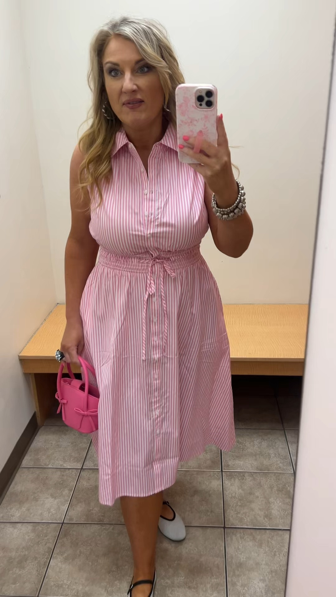 Pink and white striped sleeveless dress, midi length, elastic drawstring waist..  sizes M-XL

I’m wearing a medium. 

Pink bow purse. 

#LTKootd #LTKOver40 #LTKMidsize