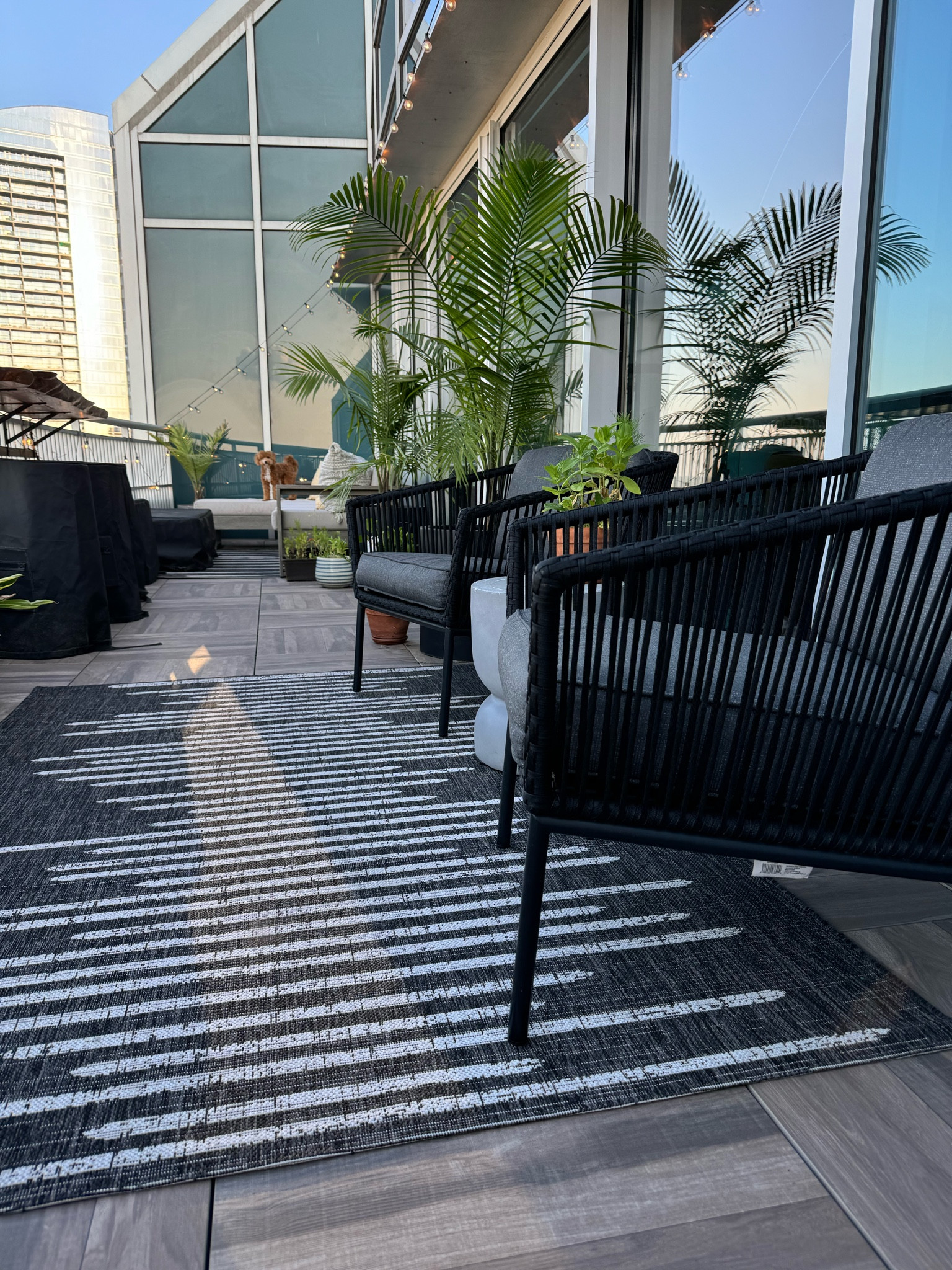 Outdoor balcony/patio space  inspiration. Outdoor sectional (in the back) is customizable from West Elm. Outdoor chairs, rugs, and side table are from Target. 

#LTKHome