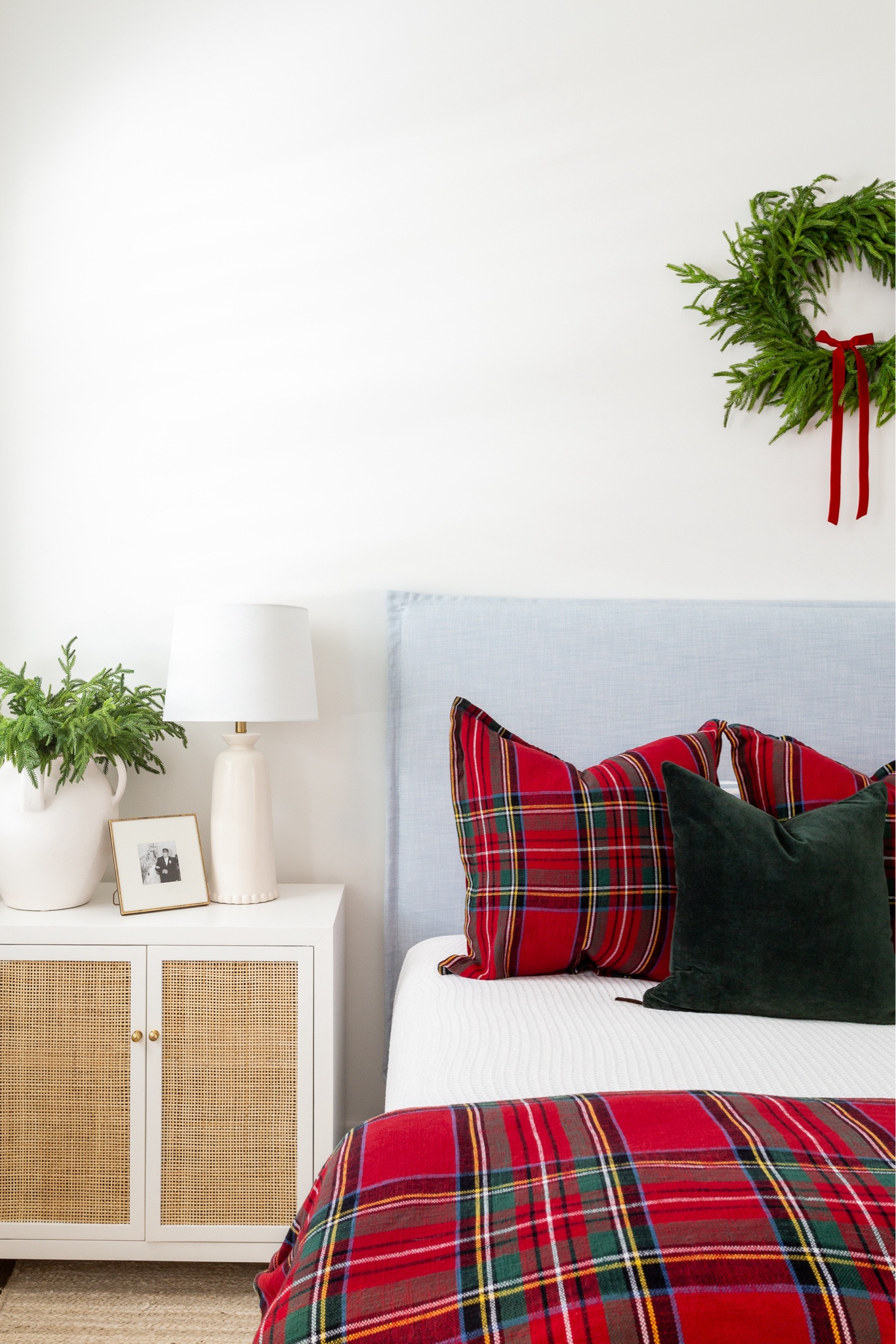 Christmas bedroom with vaulted ceilings, a light blue linen bed, white and red plaid bedding, dark green velvet pillows, a wreath with red velvet bow above the bed, bead chandelier, rattan nightstands, a rattan bench, and white jute rug. See our full Christmas home tour here: https://lifeonvirginiastreet.com/2024-christmas-home-tour/. #ltkholiday #ltkhome #ltksalealert #ltkfindsunder50 #ltkfindsunder100 #ltkseasonal #ltkstyletip 


#LTKSaleAlert #LTKHome #LTKHoliday