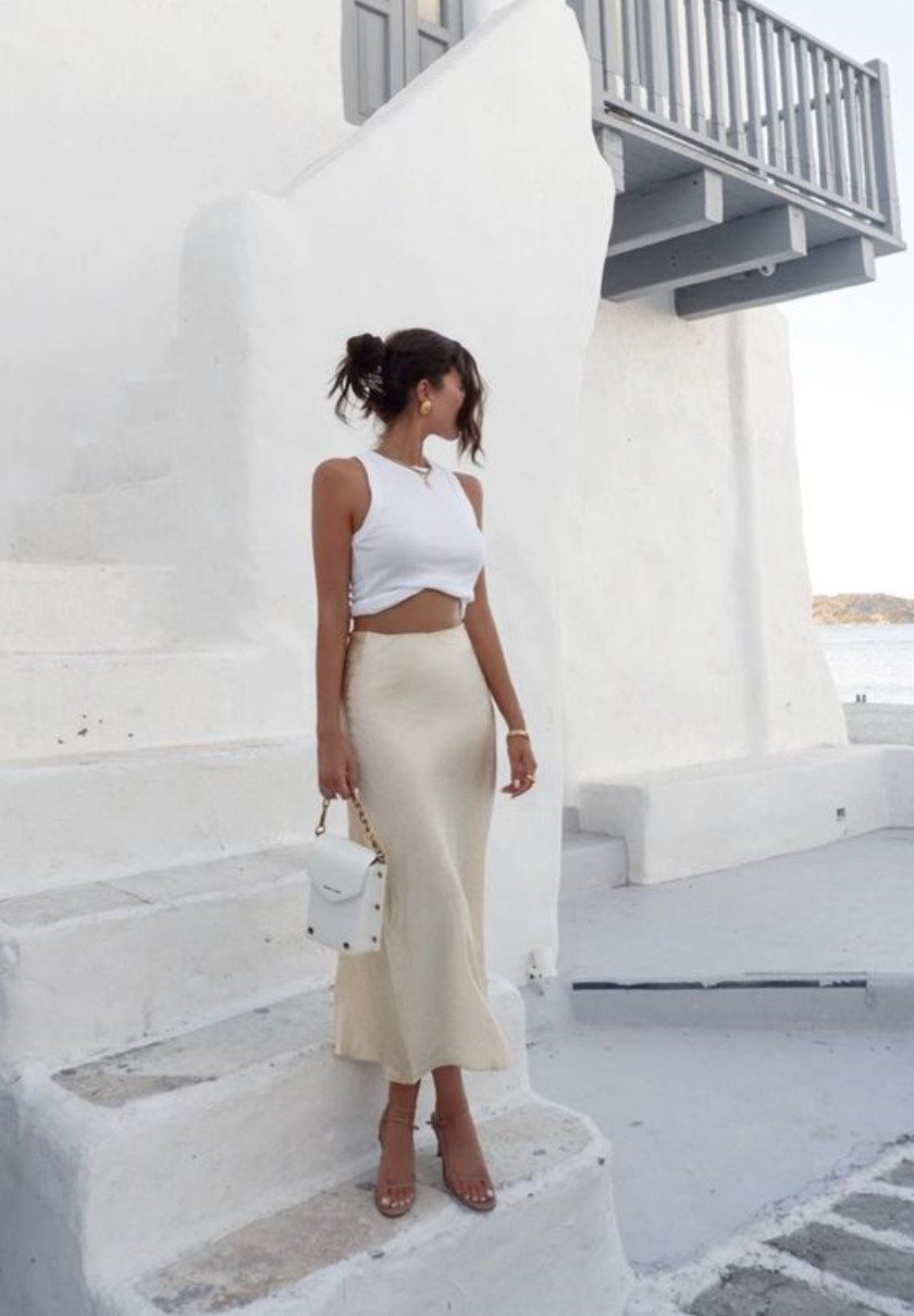 White crop top and satin midi skirt outfit for summer vacations, European travel style, and chic warm-weather outfits.
This effortless look pairs a fitted white crop top with a champagne satin midi skirt, delicate heels, and a mini bag for a minimalist, elevated summer outfit that’s perfect for vacations, dinner by the water, or warm city evenings. 

 #LTKdayinmylife #LTKootd #LTKTravel