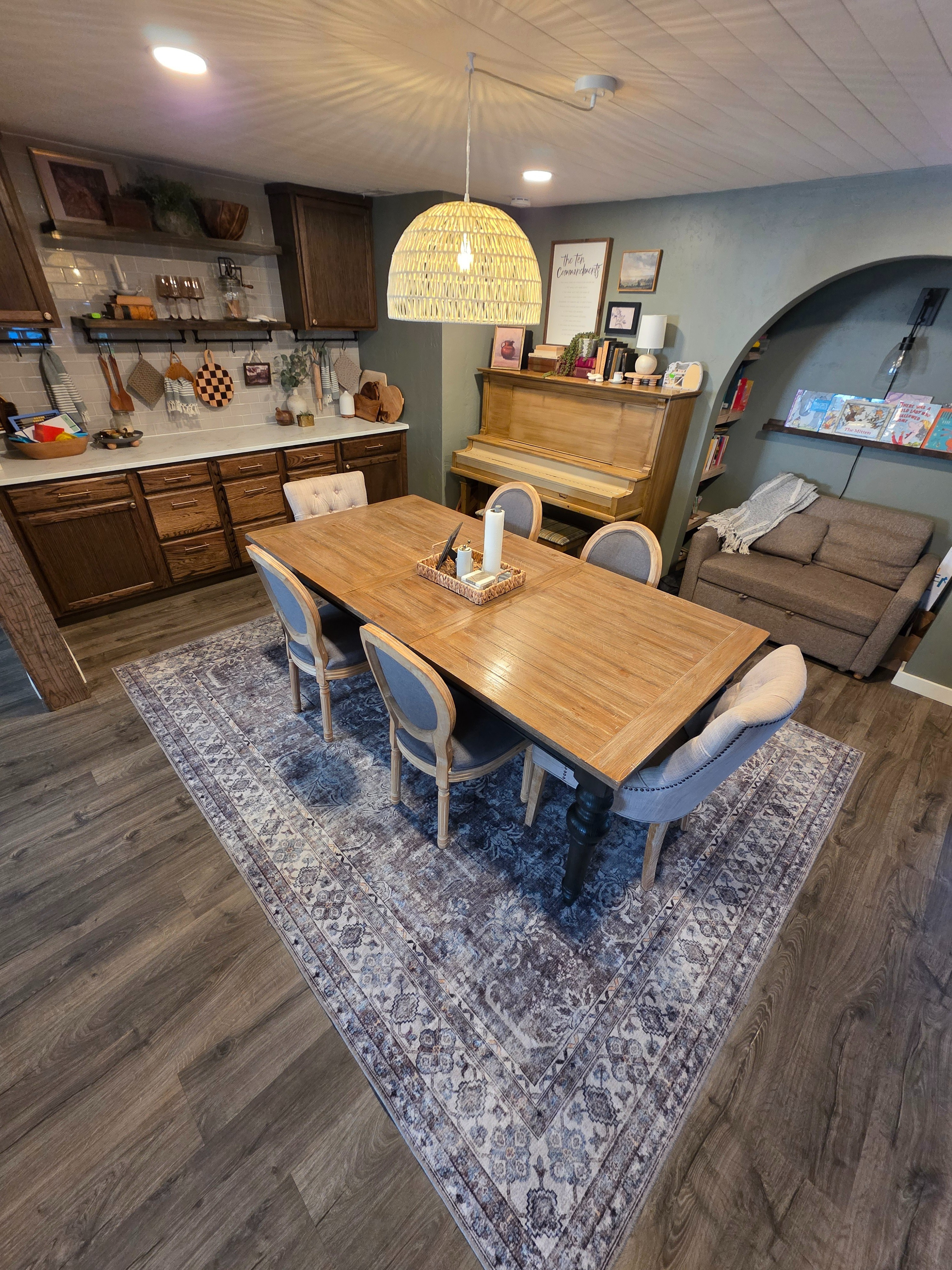 This dining room has been such a fun one to pull together, with the sage green walls, custom built-ins, and a cozy reading nook that make the piano corner feel just as inviting as the table. Transitional style is perfect for blending in warm wood tones with a few classic touches for a space that feels both fresh and lived-in. #diningroomd  

 #LTKHome