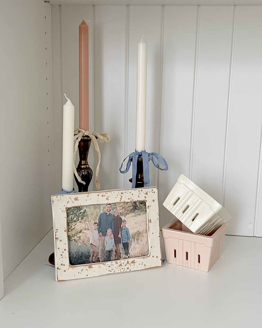 Creating a spring scene is so fun and easy! 1) Grab a Focus Piece - my framed family, photo in this scene! (2) Add Height - a classic set of candle holders with spring tapers. (3) Create Dimension with a grouping of three - angled ceramic berry baskets (4) Add a Splash of Fun/Personality - I live ribbon and popped a bow on each candle. And ta-da, you are done!! 

#LTKSeasonal #LTKHome #LTKFindsUnder50