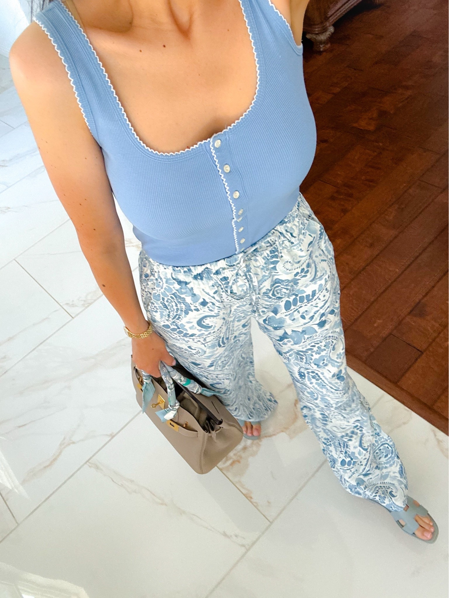Soft blues, effortless vibes, and a little paisley moment 💙✨ Summer outfits are officially my favorite season.

Blue tank on sale! I love the button details. These stunning blue floral pants are such a good buy for summer. Everything runs true to size. 

Hermes 30 Birkin. Hermes oran sandals.

#LTKTravel #LTKOver40 #LTKSaleAlert