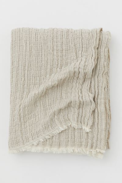 Throw in a woven, crinkled linen and organic cotton blend. Frayed, raw-edge trim. | H&M (US + CA)