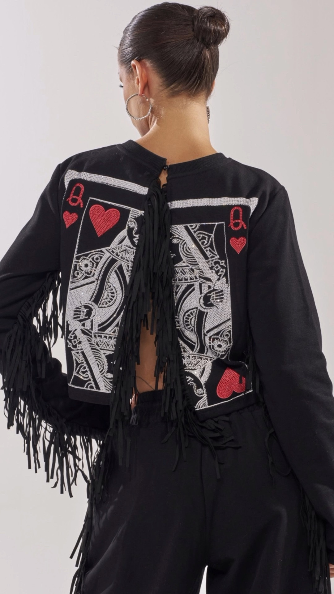 Fringe that actually makes your sweats feel runway‑ready. This all‑black lounge set has dramatic side tassels on the pants and a cropped sweatshirt with a bold Queen of Hearts playing‑card back graphic—so you look just as good from behind as you do from the front. I love this for travel days, laid‑back nights out, or anytime you want comfy pieces that still turn heads. 

#LTKootd #LTKTravel #LTKNYFW
