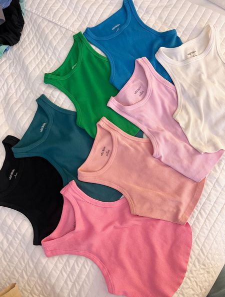 *slightly* obsessed with these ribbed tanks from Target. My collection I’ve accumulated the last two years! 🩷💙💚The pink one directly under the black one is this years style.. a little longer and scoop-type hem at bottom. 

All currently on sale for under $5!!! The best to throw on all spring and summer long ☀️

#LTKsalealert #LTKstyletip #LTKxTarget