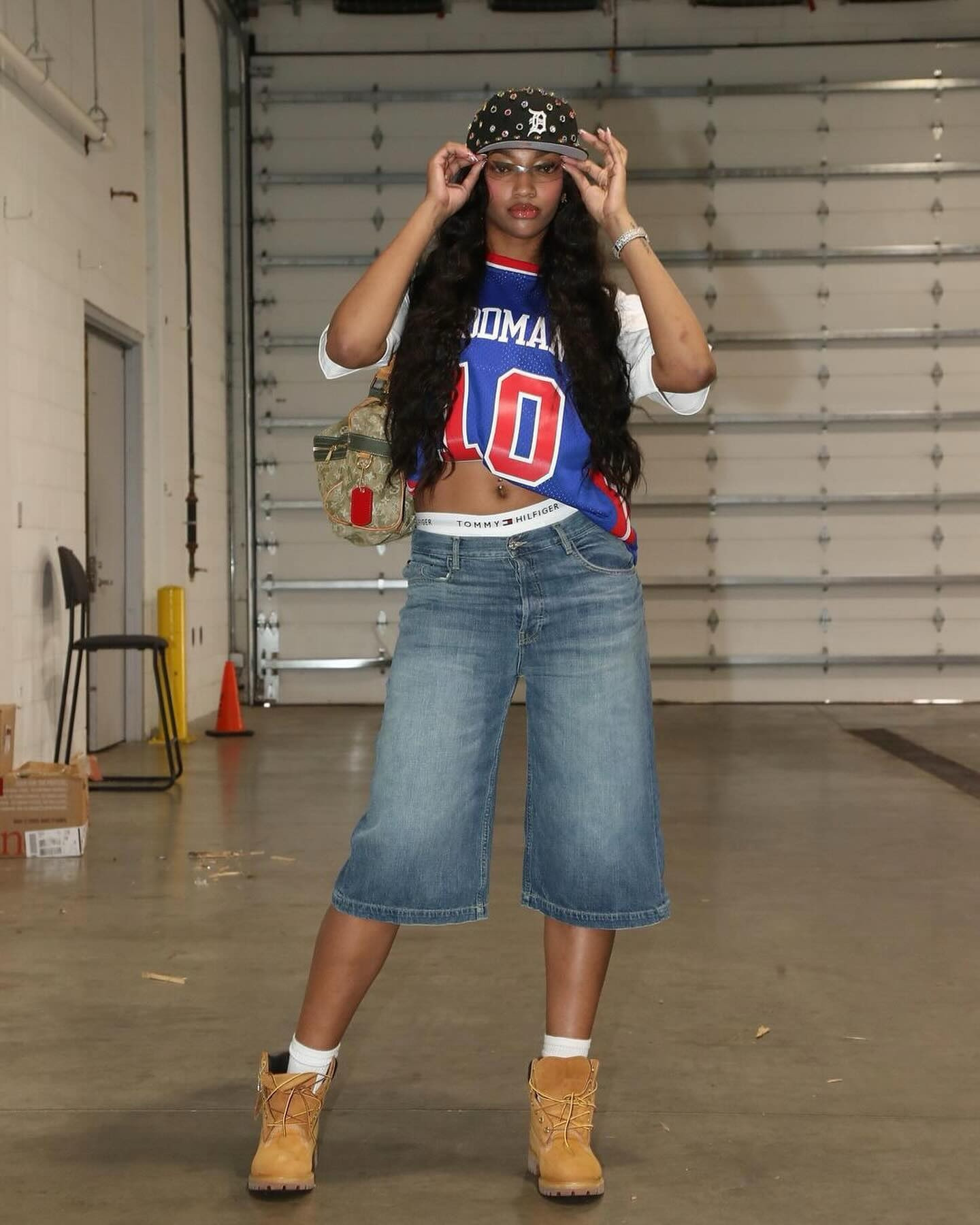 Angel Reese wears a throwback Dennis Rodman Detroit Pistons jersey, Tommy Hilfiger underwear, and Timberland boots with a Louis Vuitton bag for the Chicago Sky vs Indiana Fever game.

#LTKStyleTip #LTKVideo