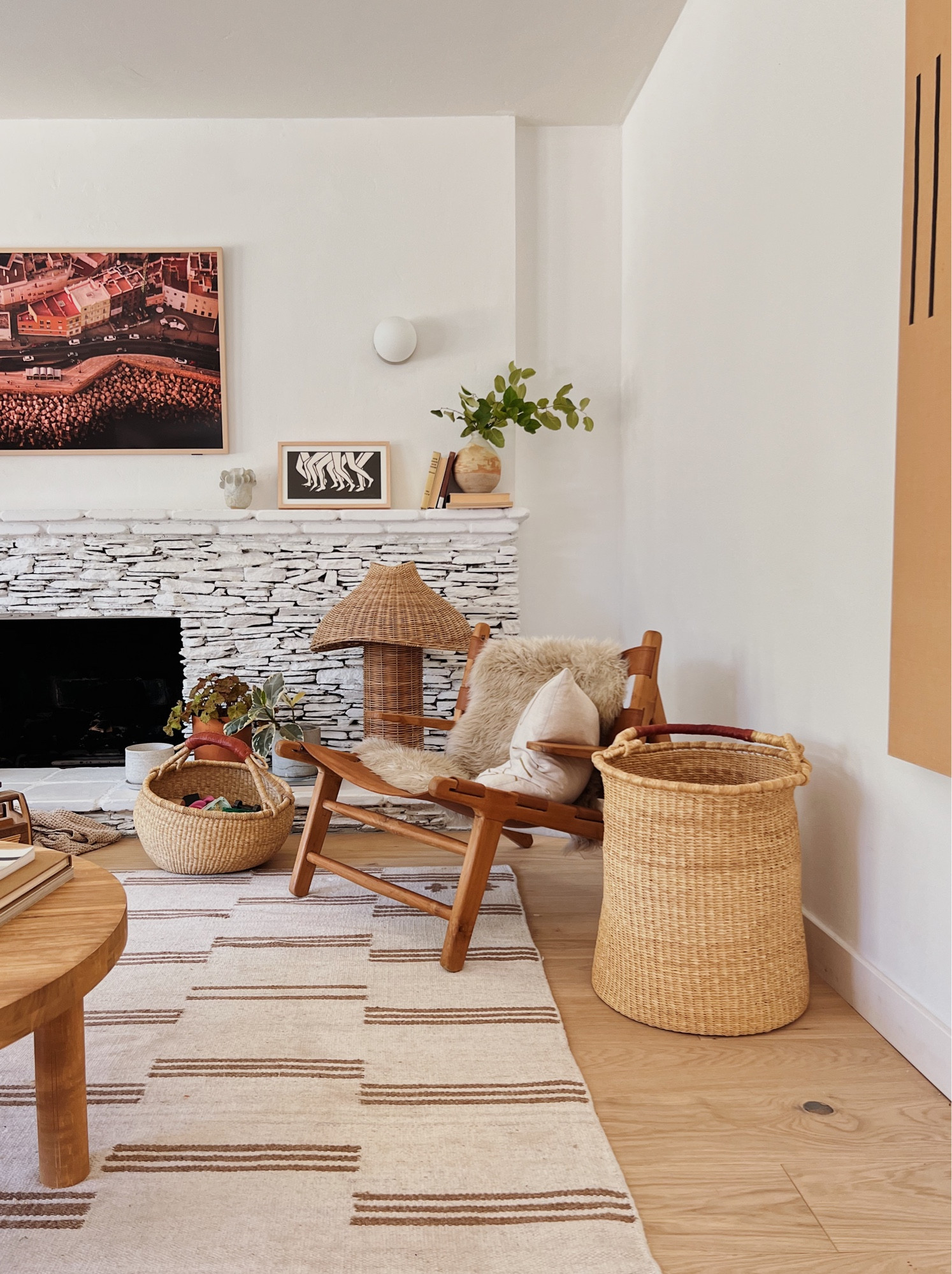 My living room is constantly changing, but here’s what it’s looking like rn.  I love the rattan table lamp right here on the fireplace. Table lamp - boho - earthy interiors - wicker - wood furniture - frame tv - organic modern - desert - woven baskets

#LTKFind #LTKhome #LTKstyletip