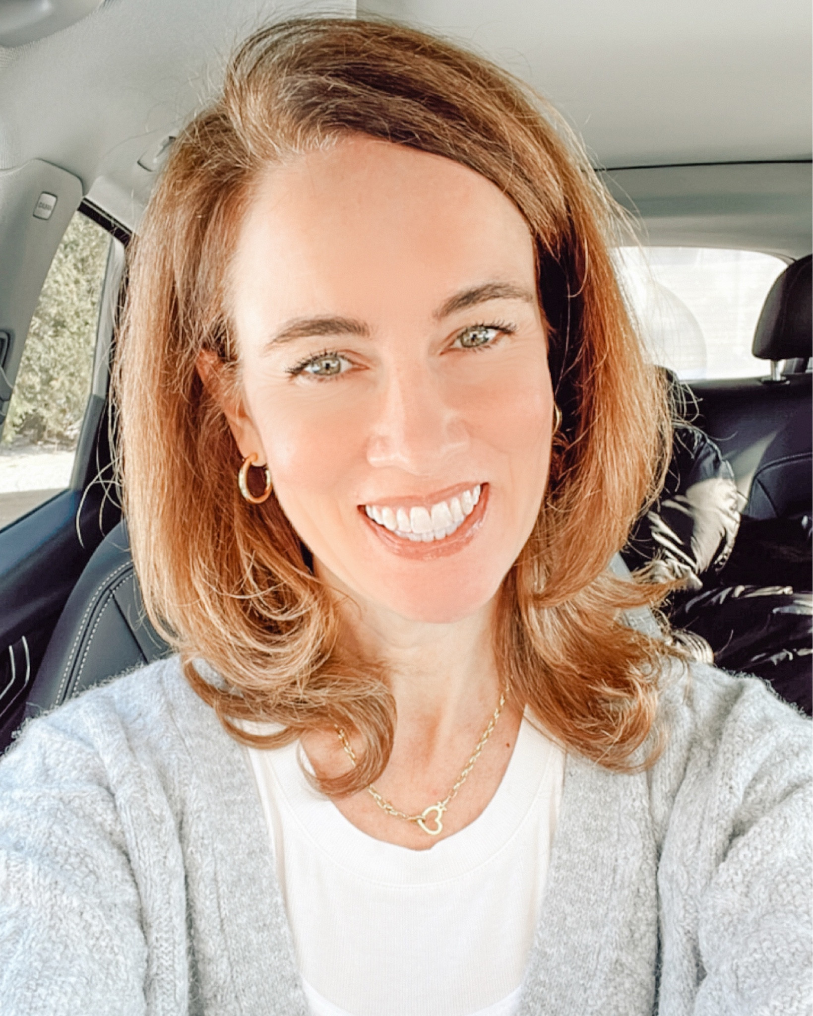 Transitioning from winter to spring outfit ideas - Wearing my Grey Topshop Cardigan with my LOFT winter white long sleeve tee and my Old Navy Ribbed Tank layered overtop.  Accessorized with my gold Gorjana hoop earrings and gold heart chain necklace.  Valentine's Day Gift Ideas #over40Style #CarSelfie #GreyCardigan #LOFT #gorjana #goldhoopearrings

#LTKMostLoved #LTKOver40 #LTKFindsUnder50